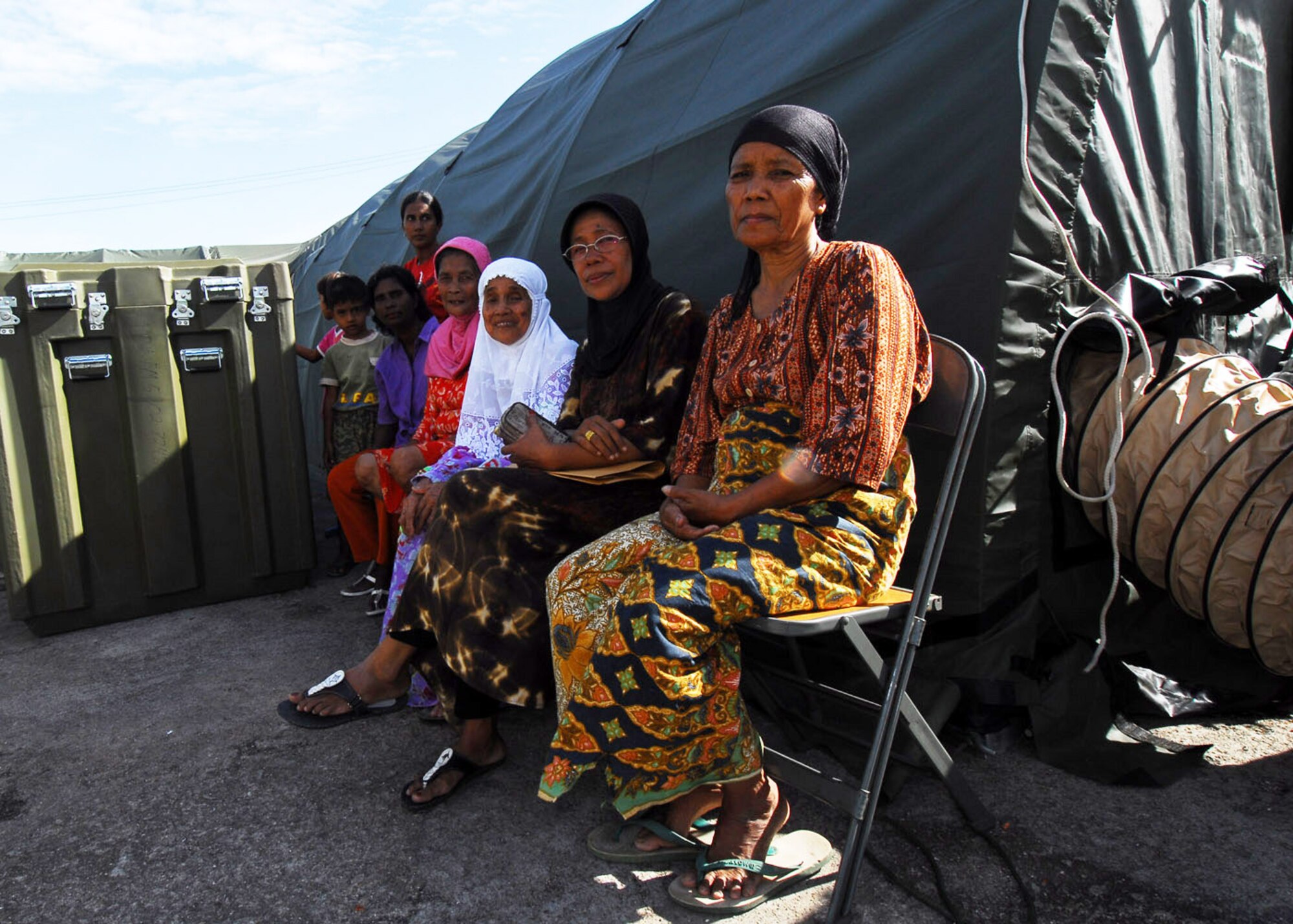 PADANG, Indonesia -- Patients wait to be examined by members of an Air Force Humanitarian Assistance Rapid Response Team Oct. 7. The HARRT has set up a mobile hospital to provide medical care to those injured by the recent earthquakes here. (U.S. Air Force photo/Staff Sgt. Veronica Pierce)