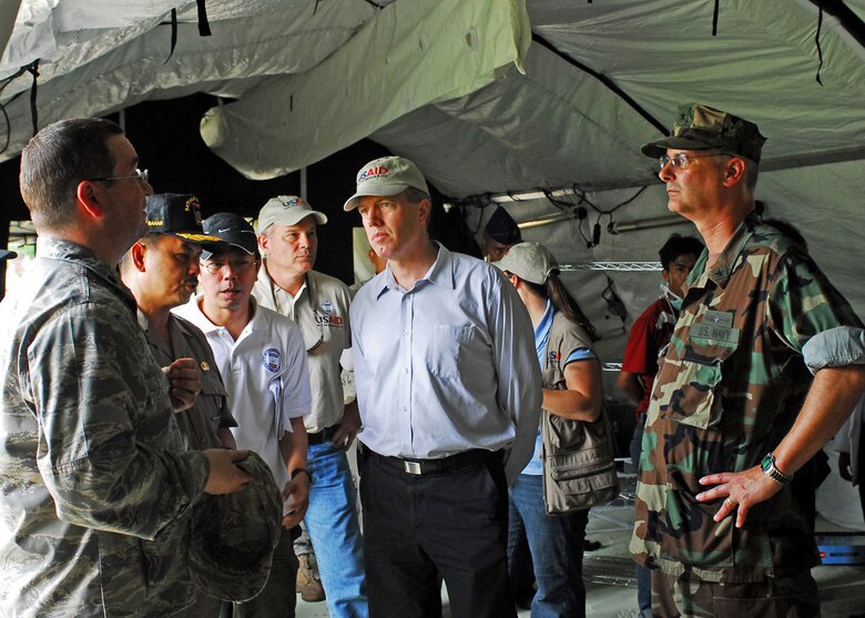 PADANG, Indonesia -- Lt. Col. David Olson, Air Force Humanitarian Assistance Rapid Response Team medical commander, (left) tours the team's field hospital during set up Oct. 6 with (left to right) Fauzi Bahar, Padang Mayor, Ted Osius, Deputy Charge de Affairs of the Disaster Assistance Response Team and Rear Adm. Richard Landolt, Amphibious Force 7th Fleet commander. (U.S. Air Force photo/Staff Sgt. Veronica Pierce)
