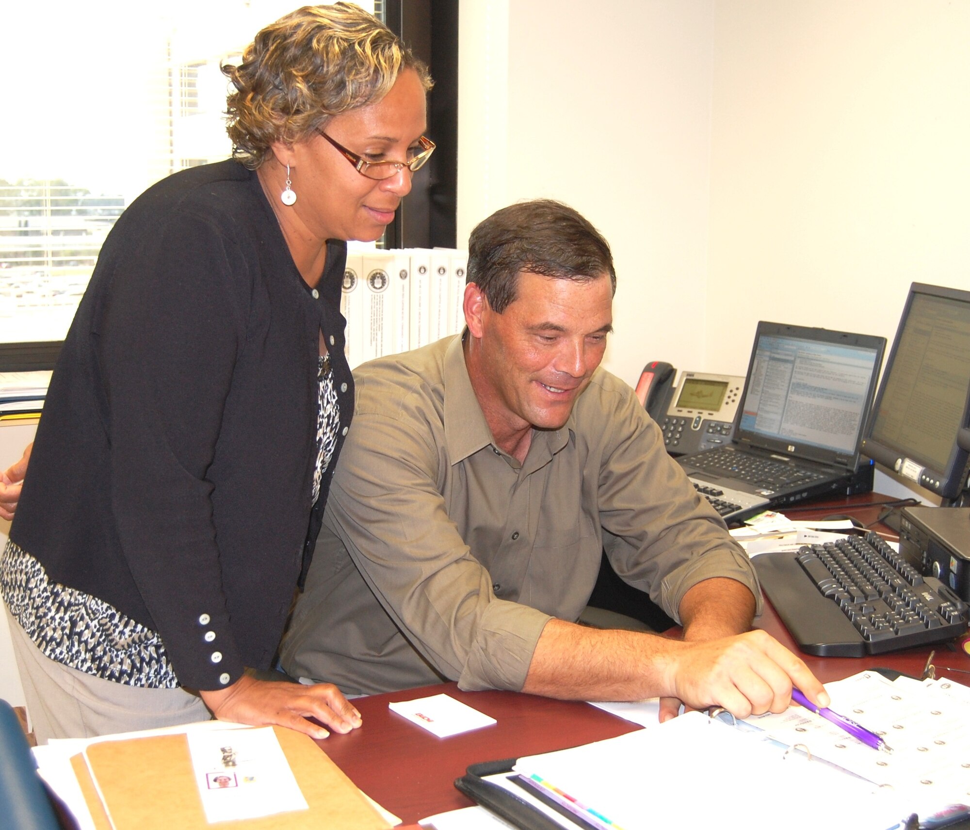 Mr. Ransom and Ms. Anderson review a case of an active-duty service member.  (U.S. Air Force photo by Steve Pivnick)