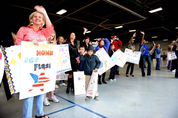 SHAW AIR FORCE BASE, S.C. -- Friends and family wave to Soldiers from the 4th Battlefield Coordination Detachment returning here from a 12-month deployment Oct. 5, after supporting air and ground operations in the U.S. Central Command Area of Responsibility. (U.S. Air Force photo/ Senior Airman Matt Davis)