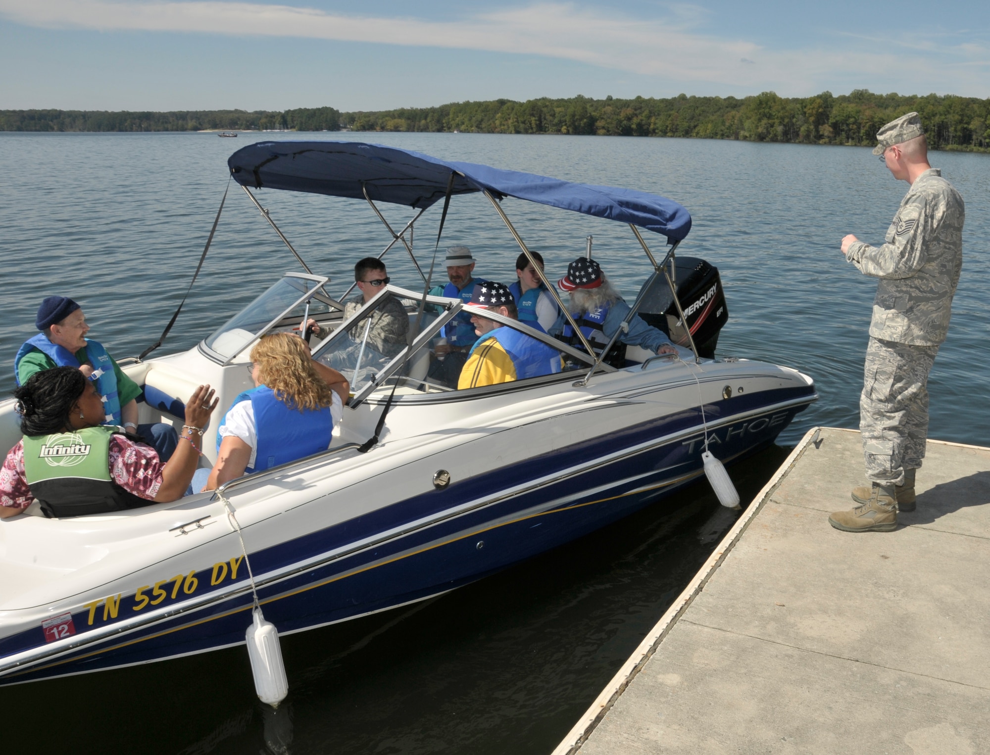 Right, Tech. Sergeant Jamie Johnson, with the 704th Maintenance Squadron and the person who helped to coordinate the VA Picnic, ensures a boat of veterans and their attendants have a safe departure for a ride on Woods Reservoir. (Photo by Rick Goodfriend)