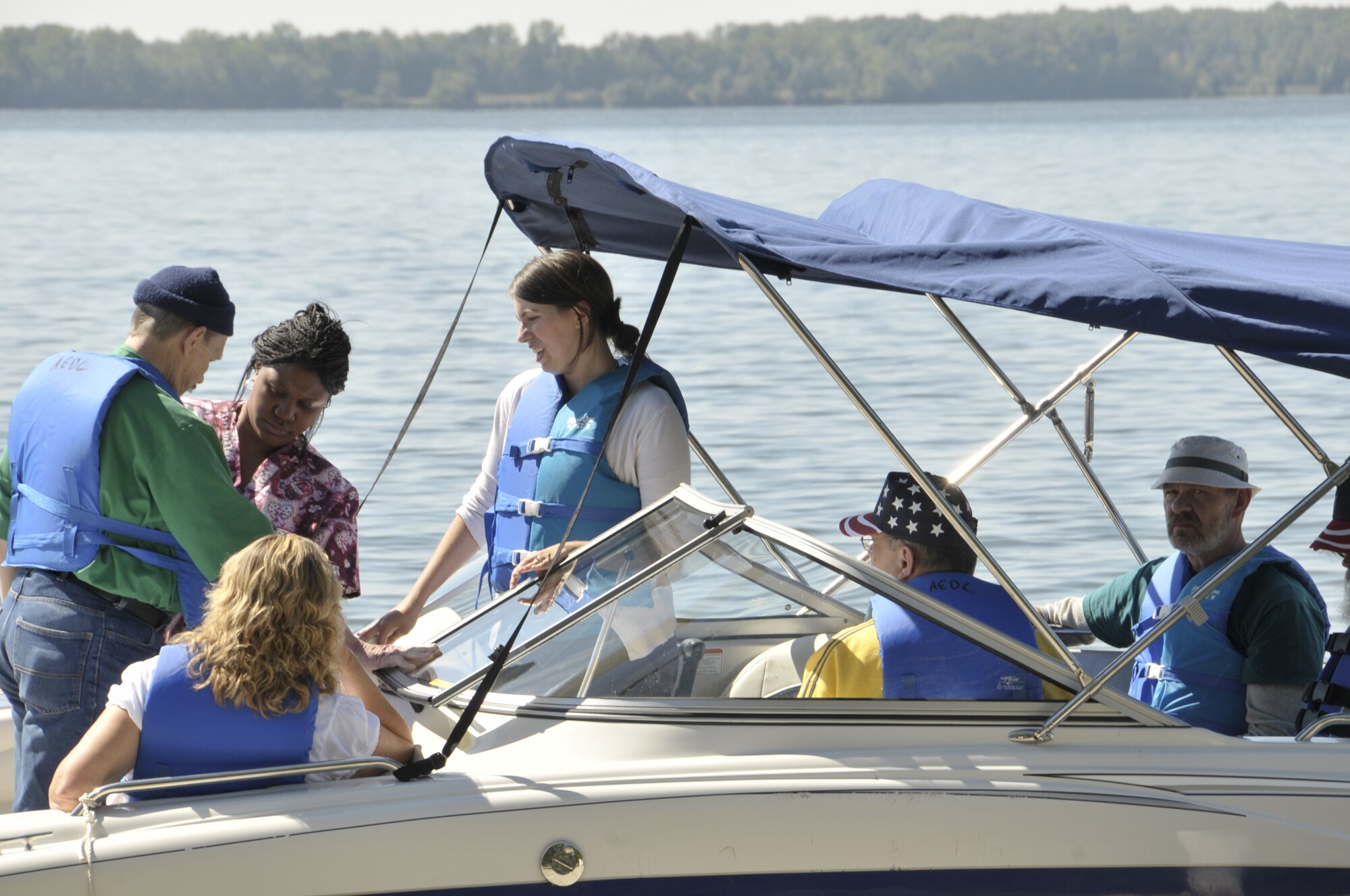 A VA staff worker helps one of the veterans don a lifejacket prior to a boat ride on Woods Reservoir during the annual VA Picnic. (Photo by Rick Goodfriend)
