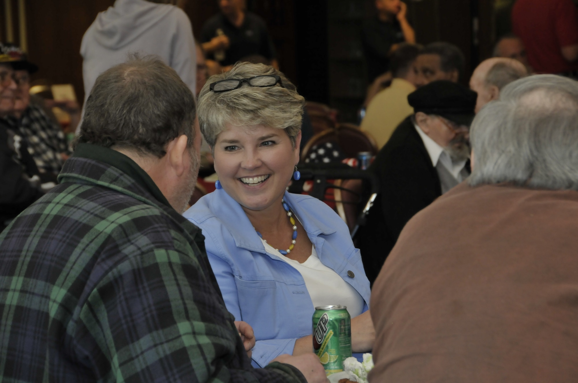 Michelle Sutton, the 704th Test Squadron’s chief of operations management and a financial management analyst, listens to a veteran speak about his living arrangements at a group home for other veterans. (Photo by Rick Goodfriend)