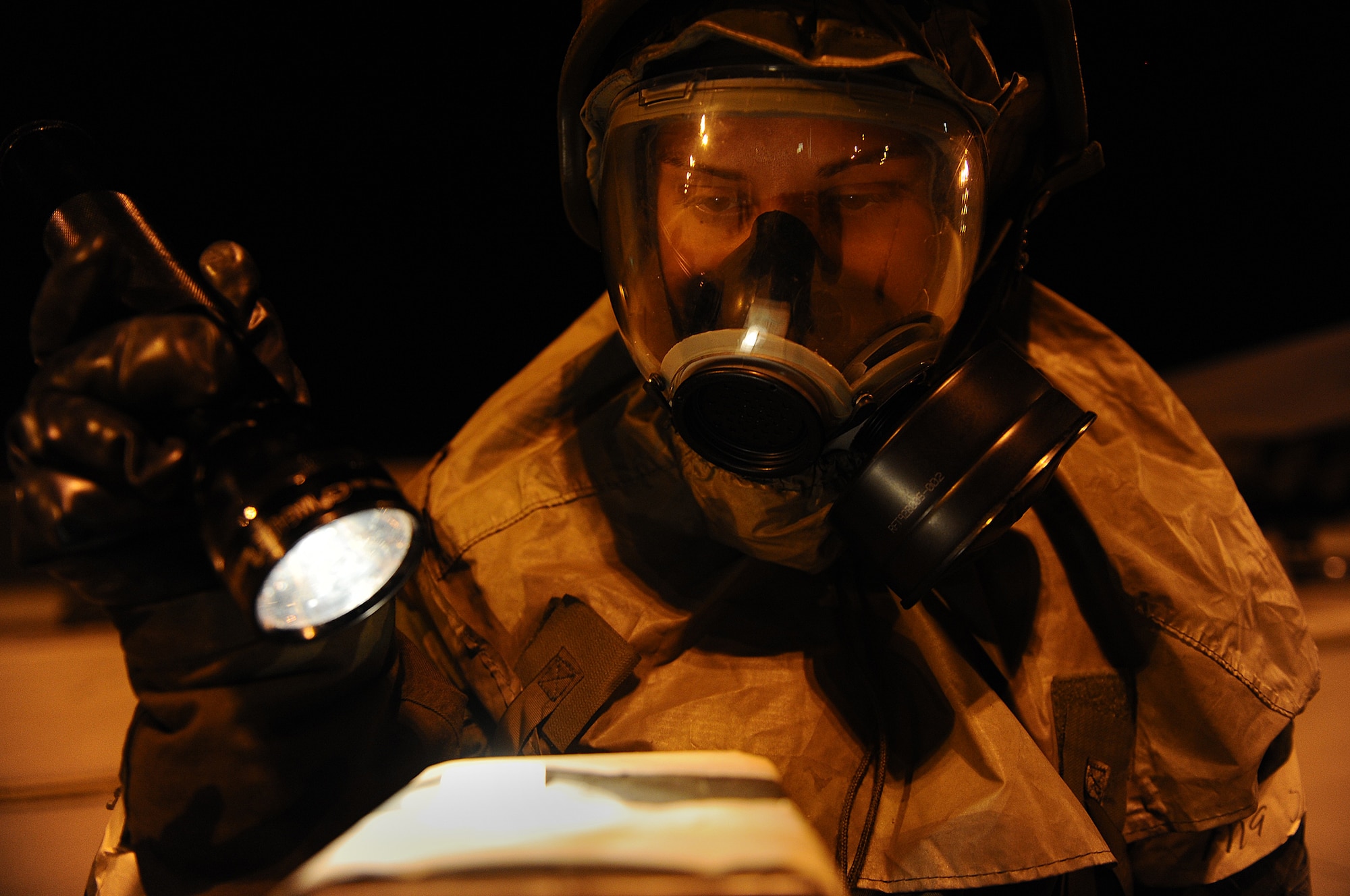 Airman 1st Class Samantha Bevilacqua, 28th Aircraft Maintenance Squadron integrated flight controls apprentice, inspects a simulated M-8 paper to see if the area has been contaminated during a Phase II Operational Readiness Exercise here, October 6.  Ellsworth Airmen undergo numerous training missions during a Phase II ORE. (U.S. Air Force photo/Airman 1st Class Joshua J. Seybert) 