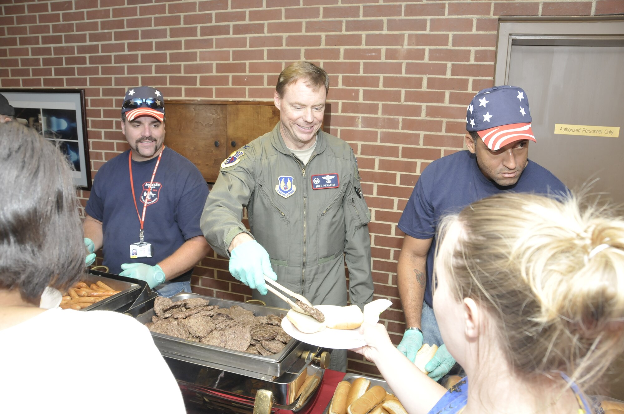 Arnold Engineering Development Center Commander Col. Michael Panarisi serves a hot dog to one of the VA recreational techs during the annual VA Picnic, which Arnold Air Force Base has hosted since 1992. (Photo by Philip Lorenz III)