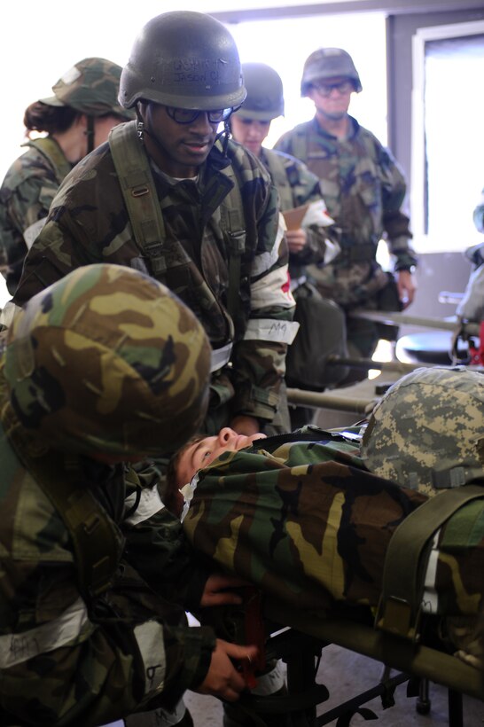 Airman 1st Class Ashton Horsting, 28th Medical Operations Squadron medical technician, secures the mock patient’s litter to a stand while Tech. Sgt. Jackson Clark, 28 MDOS medical technician, steadies the litter during a Phase II Operational Readiness Exercise here, October 6. A Phase II exercise is designed to prepare Airmen for deployed operations, including chemical warfare attacks. (U.S. Air Force photo/Senior Airman Kasey Zickmund)