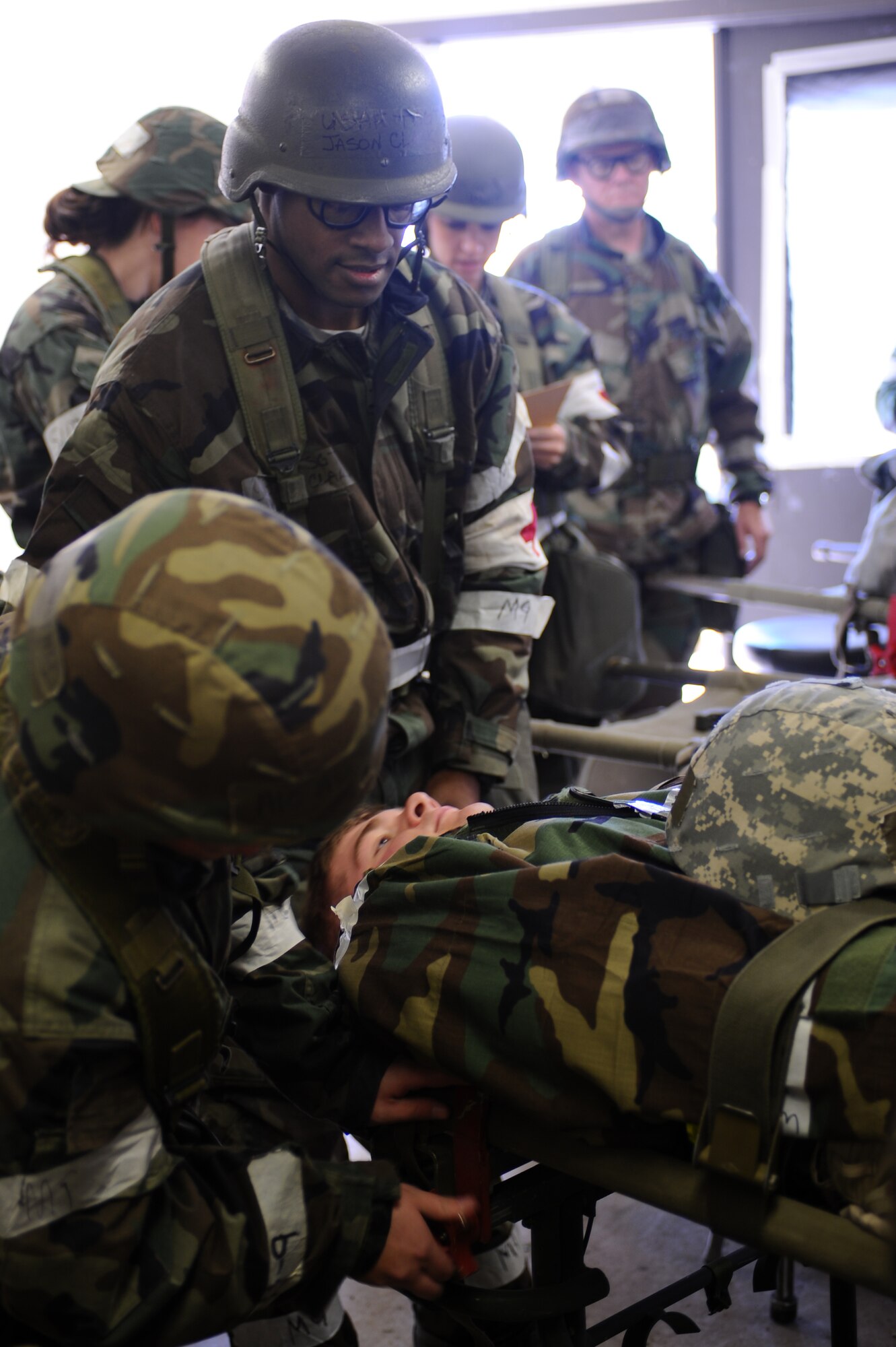 Airman 1st Class Ashton Horsting, 28th Medical Operations Squadron medical technician, secures the mock patient’s litter to a stand while Tech. Sgt. Jackson Clark, 28 MDOS medical technician, steadies the litter during a Phase II Operational Readiness Exercise here, October 6. A Phase II exercise is designed to prepare Airmen for deployed operations, including chemical warfare attacks. (U.S. Air Force photo/Senior Airman Kasey Zickmund)