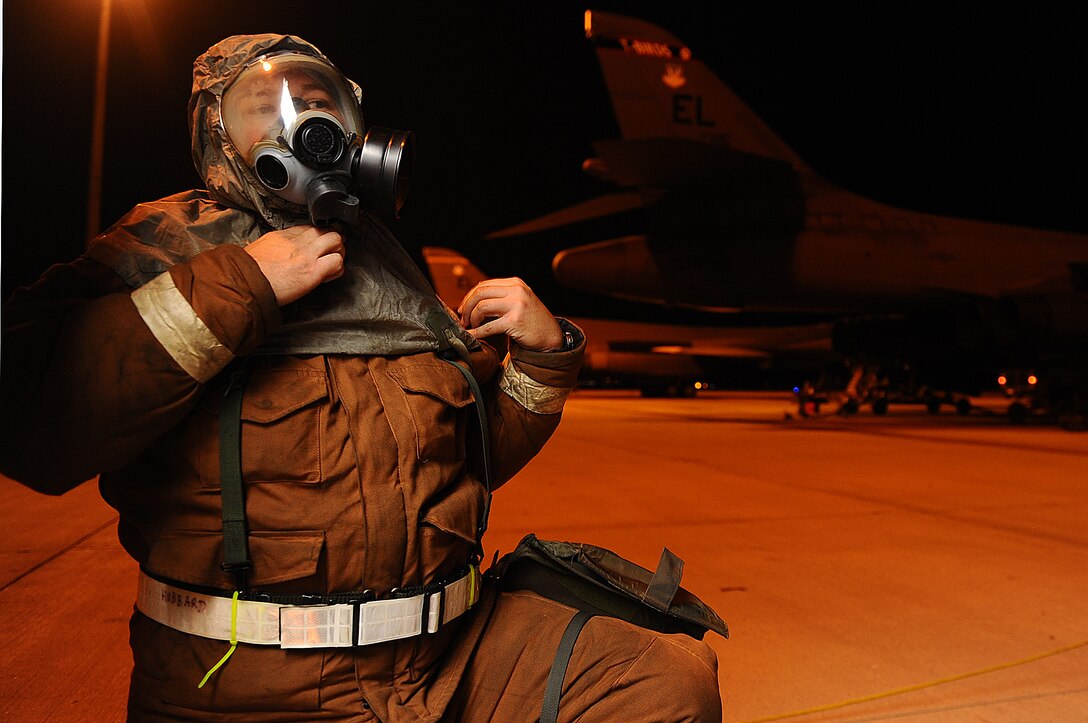 Tech. Sgt. Douglas Hubbard, 28th Aircraft Maintenance Squadron aerospace propulsion craftsman, puts on his gas mask during a Phase II Operational Readiness Exercise here, October 6.  The exercise is designed to test Airmen’s knowledge about what to do in a deployed combat situation. (U.S. Air Force photo/Airman 1st Class Joshua J. Seybert) 