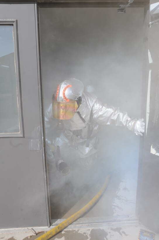 Tech. Sgt. David Ross, 28th Aircraft Maintenance Squadron crew chief, vacates a simulated burning building after all Airmen have been evacuated here, October 6.  The simulation was part of a Phase II Operational Readiness Exercise, which resembles operations in a deployed location. (U.S. Air Force photo/Airman 1st Class Anthony Sanchelli)