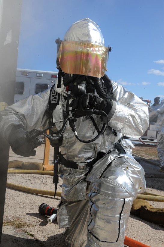 Staff Sgt. Anthony White, 28th Civil Engineer Squadron firefighter, radios in before entering a simulated burning building during a Phase II Operational Readiness Exercise here, October 6. The exercise is designed to test Airmen’s knowledge about what to do in a deployed combat situation. (U.S. Air Force photo/Senior Airman Kasey Zickmund)