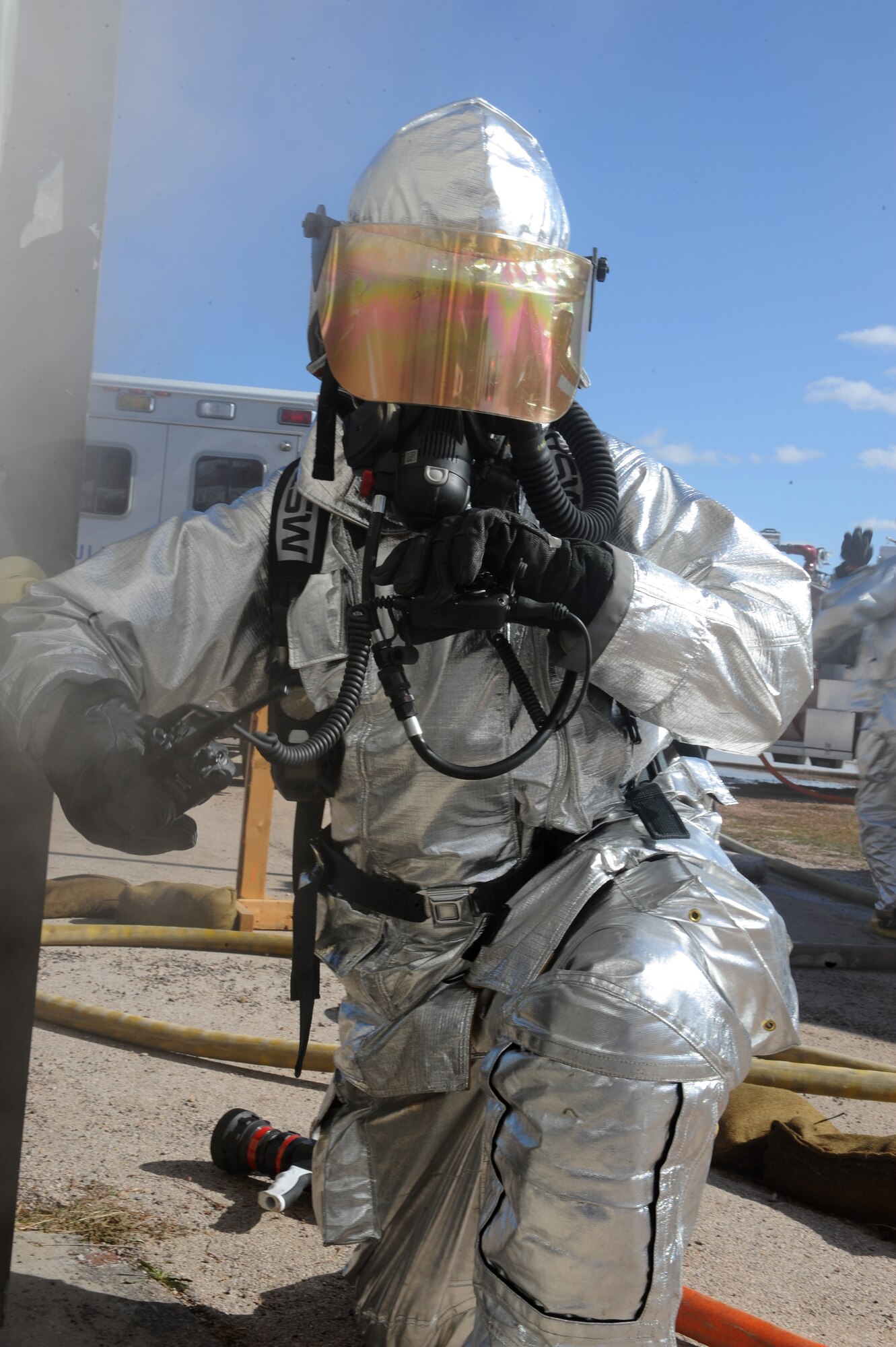 Staff Sgt. Anthony White, 28th Civil Engineer Squadron firefighter, radios in before entering a simulated burning building during a Phase II Operational Readiness Exercise here, October 6. The exercise is designed to test Airmen’s knowledge about what to do in a deployed combat situation. (U.S. Air Force photo/Senior Airman Kasey Zickmund)