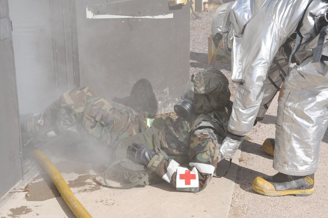 Airman 1st Class Cody Simpson, 28th Civil Engineer Squadron firefighter, drags Tech. Sgt. Michael Brown, 28th Medical Operations Squadron NCO in charge of family health, from a simulated burning building here, October 6.  Ellsworth Airmen undergo numerous training missions during a Phase II Operational Readiness Exercise. (U.S. Air Force photo/Airman 1st Class Anthony Sanchelli)