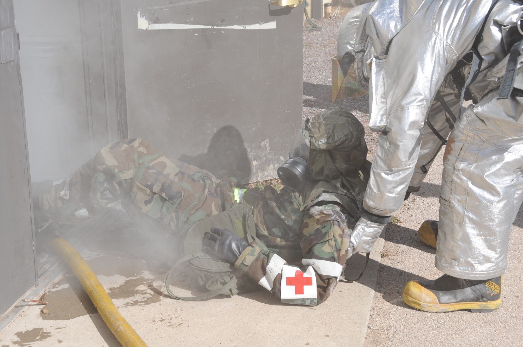 Airman 1st Class Cody Simpson, 28th Civil Engineer Squadron firefighter, drags Tech. Sgt. Michael Brown, 28th Medical Operations Squadron NCO in charge of family health, from a simulated burning building here, October 6.  Ellsworth Airmen undergo numerous training missions during a Phase II Operational Readiness Exercise. (U.S. Air Force photo/Airman 1st Class Anthony Sanchelli)