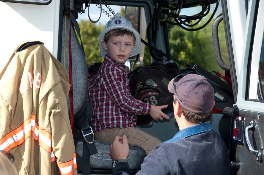 HANSCOM AIR FORCE BASE, Mass. – Matheson MacLeod, sits in the cab of one of Hanscom’s fire trucks during a visit to the Child Development Center by members of the Base Fire Department for Fire Prevention Week. The Fire Department hosted a number of educational events and visits across the base throughout the week to educate the base community on the importance of fire safety. On Oct. 10, the Fire Department will hold a Fire Prevention Walk at Castle Park from 11 a.m. to 4 p.m. The event will include several fire safety demonstrations, an amusement area for children and plenty of food and refreshments in addition to fire prevention giveaways and prizes. The entire Hanscom community is welcome to attend the free family event which is part of Hanscom’s Year of the Air Force Family celebrations. (U.S. Air Force photo by Rick Berry)