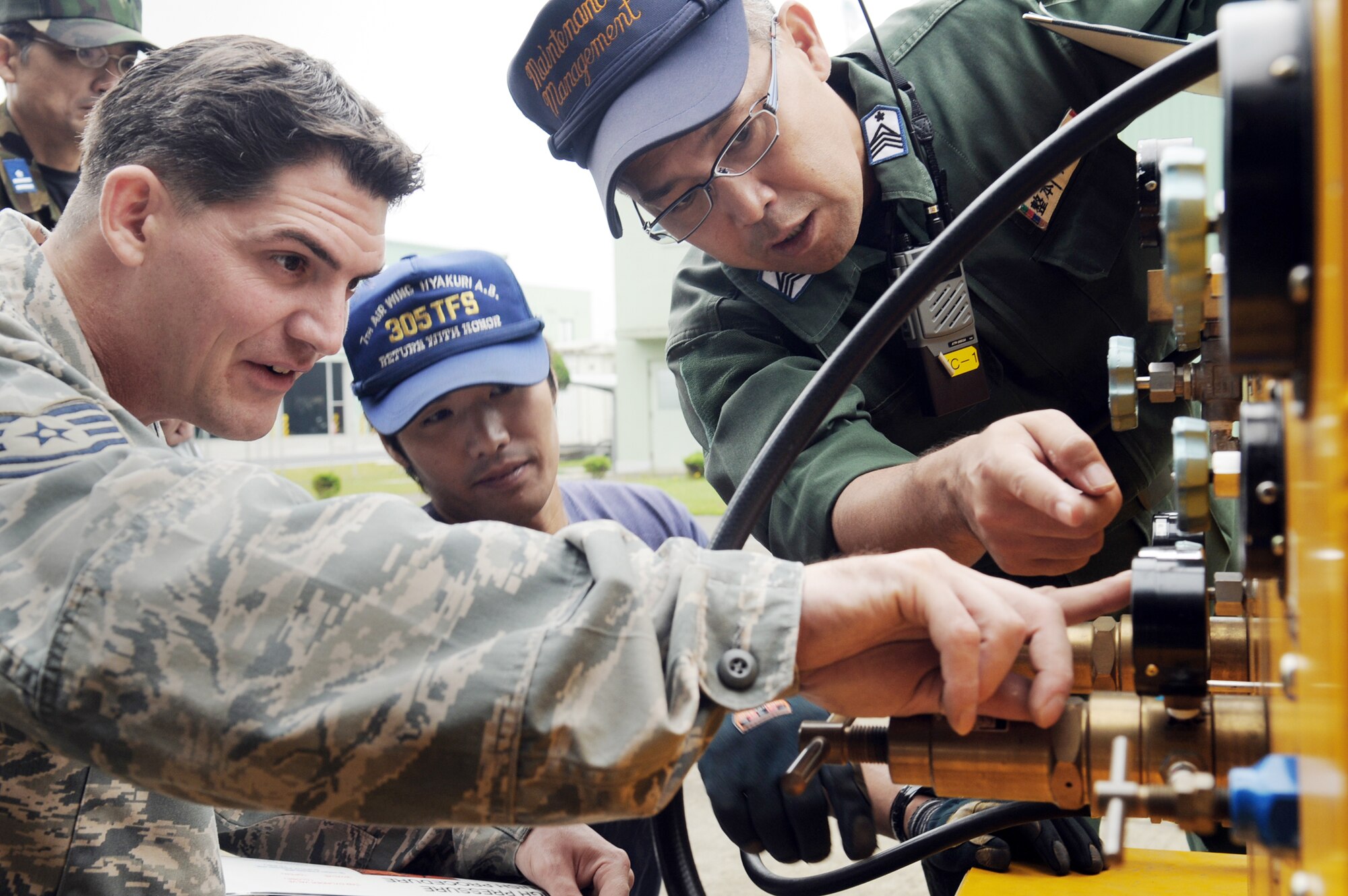 Tech. Sgt. Kevin Charrier receives training from Japan Air Self Defense Force members on aerospace ground equipment they will use during their Oct. 3, 2009, visit to Hyakuri Air Base, Japan. The visit is part of an aviation training relocation exercise between Kadena AB, Okinawa and Japan Air Self Defense Force members. Sergeant Charrier is an expeditor with the 67th Aircraft Maintenance Unit from Kadena Air Base, Japan. (Courtesy photo) 