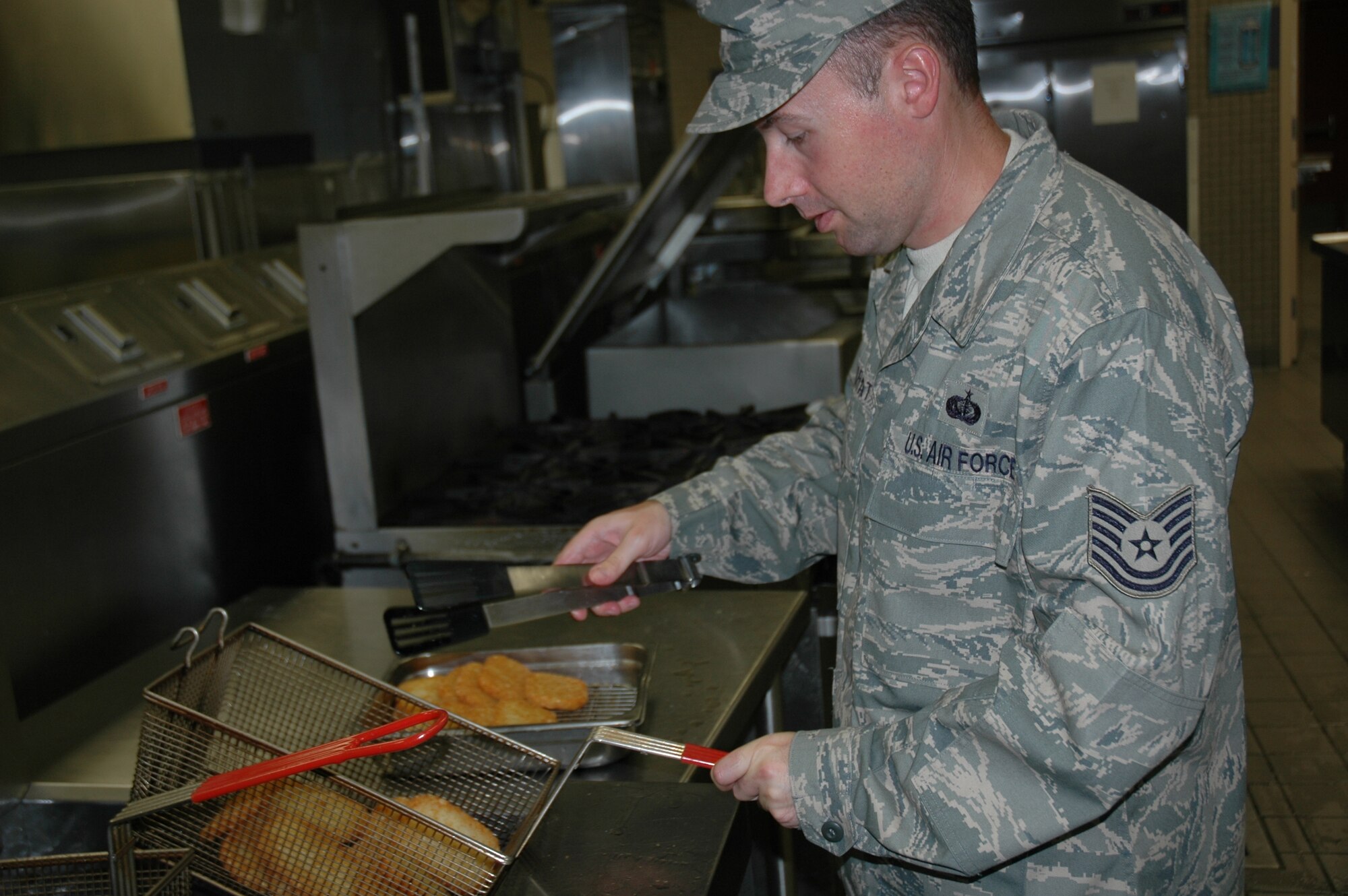 Staff Sergeant Jeffery Charvat of the 944th Services Flight cooks for airmen Sunday, Sept. 13, in the Ray V. Hensman Dining Facility, Luke Air Force Base. (U.S. Air Force photo/Senior Airman Andre Bowser)