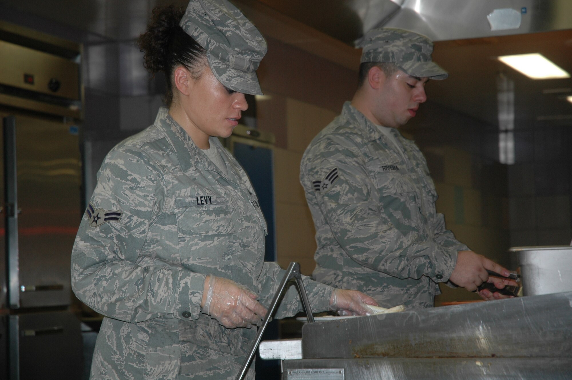 Airman First Class Kyla Levy of the 944th Services Flight cooks for airmen Sunday, Sept. 13, in the Ray V. Hensman Dining Facility, Luke Air Force Base. (U.S. Air Force photo/Senior Airman Andre Bowser)