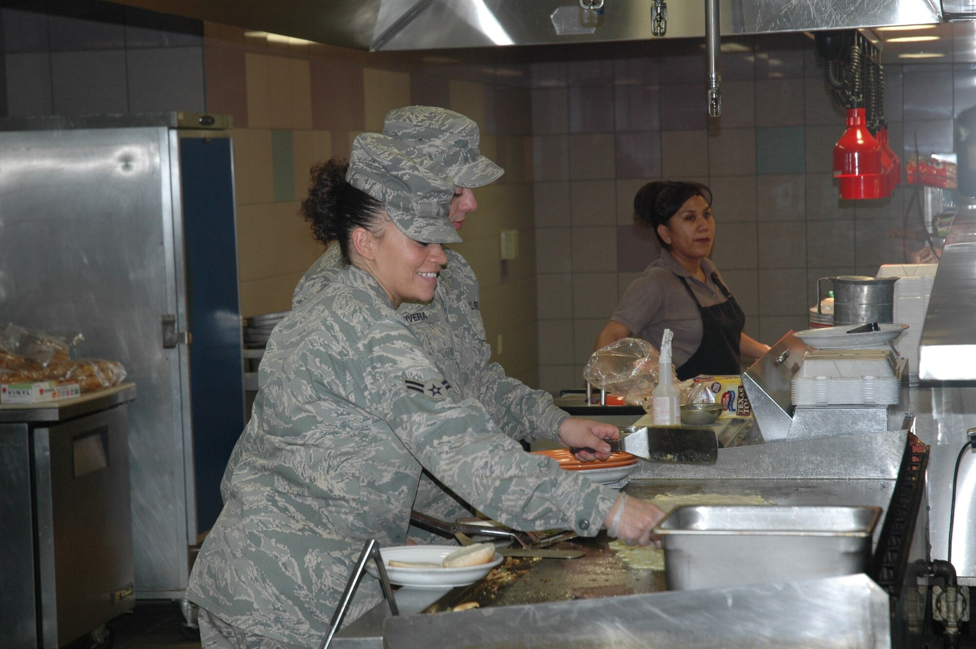 Airman First Class Kyla Levy of the 944th Services Flight cooks for airmen Sunday, Sept. 13, in the Ray V. Hensman Dining Facility, Luke Air Force Base. (U.S. Air Force photo/Senior Airman Andre Bowser)