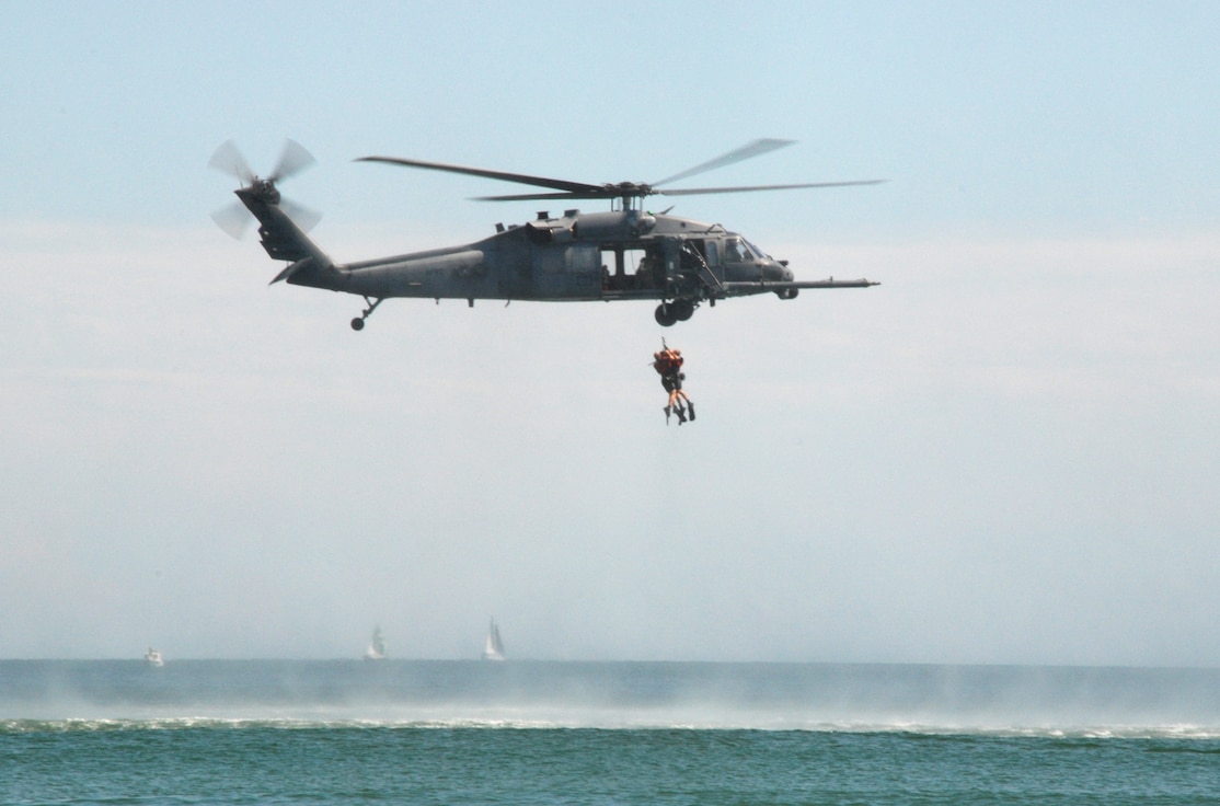 PATRICK AIR FORCE BASE, Fla. – One of the two HH-60 Pave Hawk helicopters from the 920th Rescue Wing here, simulates a rescue demonstration by hoisting two pararescuemen from the water during the Cocoa Beach Air Show Oct. 2-4, 2009. Saving lives is at the heart of everything we do. It doesn’t matter if it’s a downed F-16 pilot in Iraq, astronauts who have bailed out from the space shuttle, hurricane victims stranded on rooftops or a fisherman trapped aboard a sinking ship in the Atlantic Ocean. If the 920th Rescue Wing gets the call, we’re going to get them to safety. (U.S. Air Force photo by/Master Sgt. Bryan Ripple)