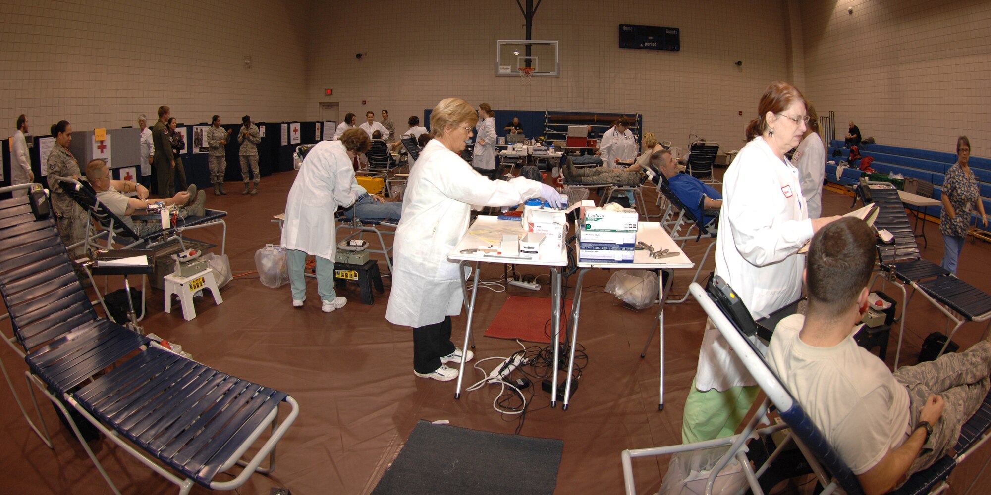 Members of the 22nd Medical Group and American Red Cross representatives collect blood from Team McConnell doners during a blood drive at McConnell Air Force Base, Kan., Oct. 2, 2009.  Donors gave more than 100 productive units of blood.  The American Red Cross and Team McConnell, partners since 1991, hold blood drives here five times per year. (U.S. Air Force photo/Staff Sgt. Jamie Train)