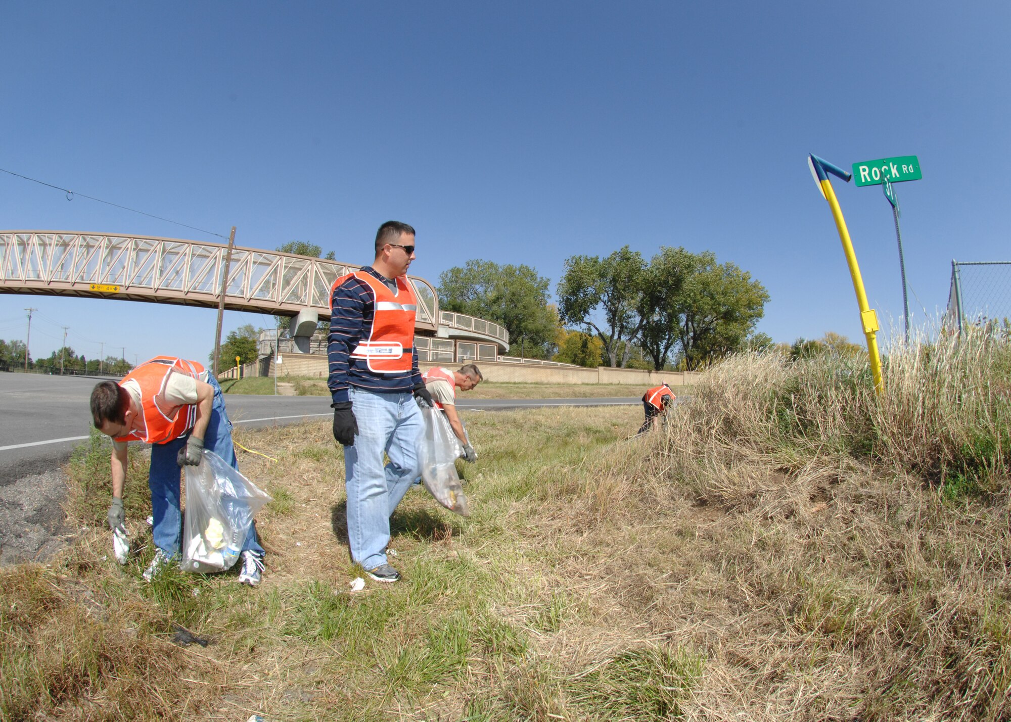 Airmen from the 22nd Communications Squadron pick up trash along Rock Road in Wichita, Kan., Oct. 2, 2009, as part of the Kansas Adopt-A-Highway program. The Airmen collected more than 50 bags of trash along a six-mile stretch. The program offers volunteer organizations an opportunity to maintain sections of roadside and help beautify the state. (U.S. Air Force photo/Staff Sgt. Jamie Train)