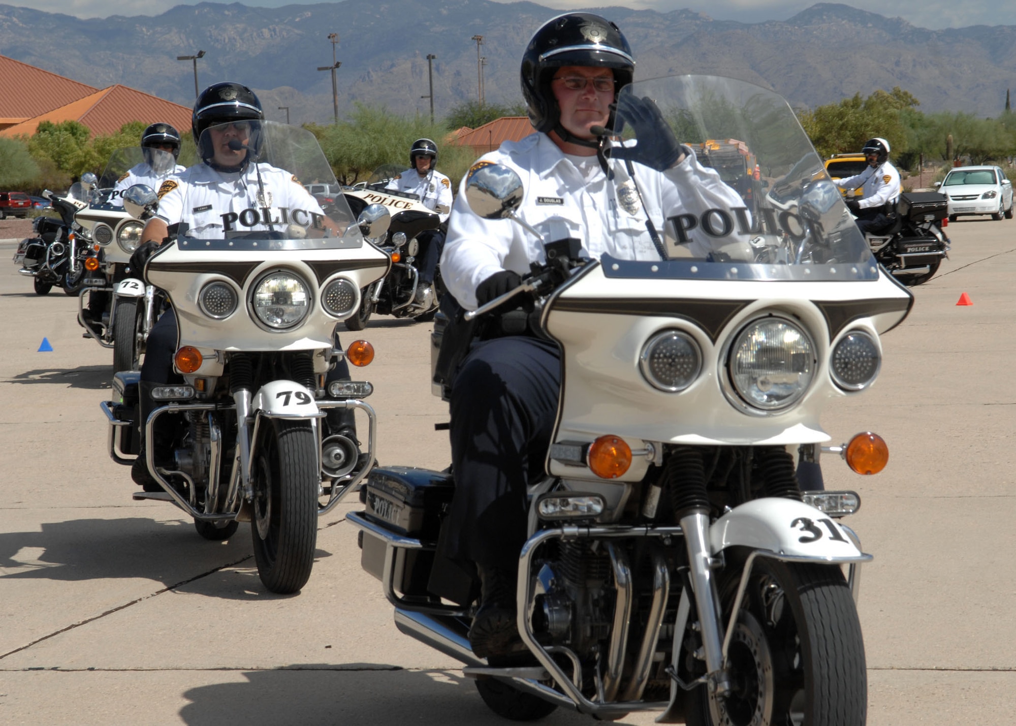 Members of the Tucson Police Department demonstrate their motorcycle handling skills during Safety Day at Heritage Park Sept. 30. Safety Day was sponsored by the 355th Fighter Wing Safety office and featured (how many) booths that focused on basic safety and awareness. (U.S. Air Force photo/Airman Jerilyn Quintanilla)