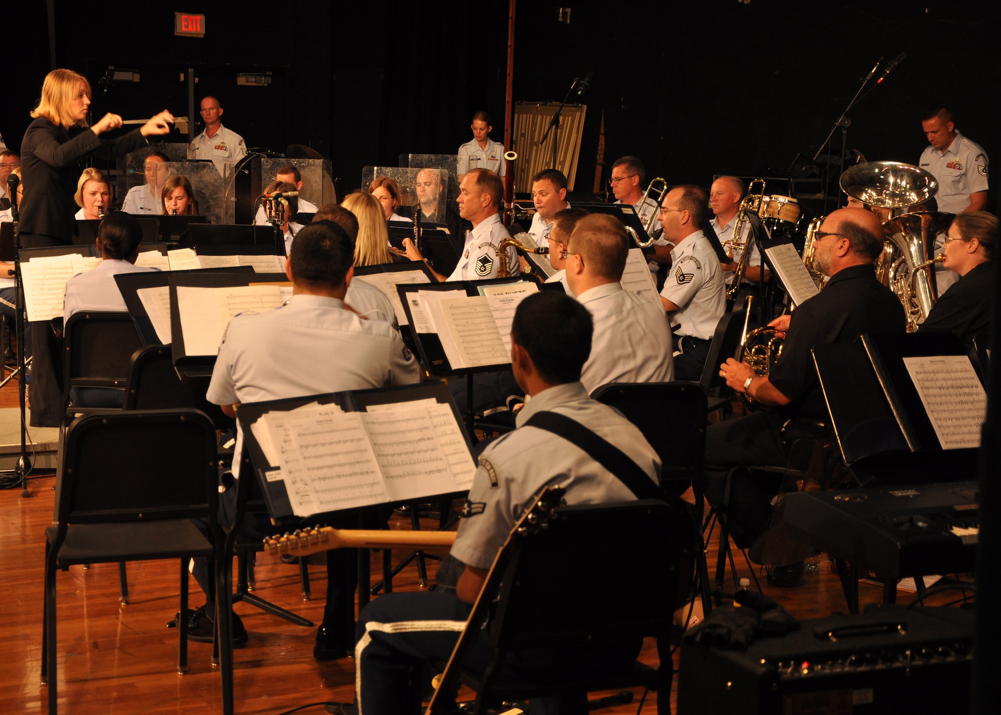 Kelly Delinski, Choctawhatchee High School assistant band director, conducts the Band of the United States Air Force Reserve during a performance Oct. 2 at the high school’s auditorium in Fort Walton Beach. The 40-member reserve band played for more than 300 band members from the high school and local middle school.  (U.S. Air Force photo/Staff Sgt. Bryan Franks)