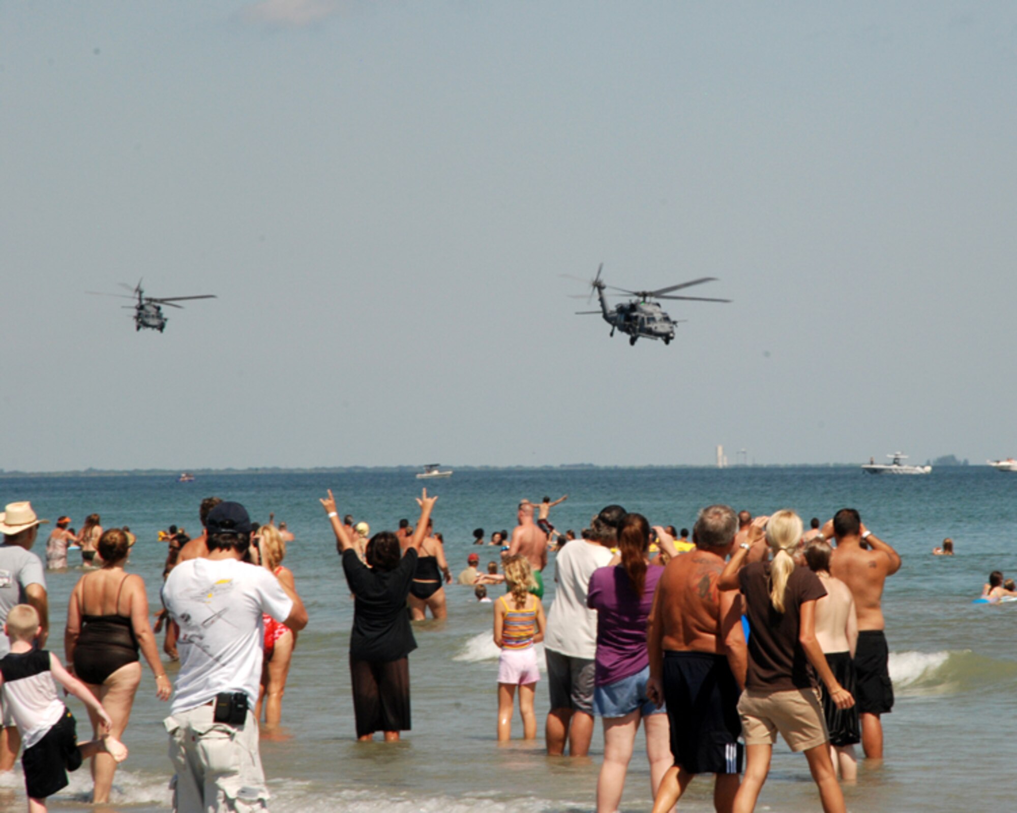 PATRICK AIR FORCE BASE, Fla. – Spectators on the beach during the Cocoa Beach Air Show, Oct. 2-4, 2009, cheer on the 920th Rescue Wing's HH-60 Pave Hawk crews, from here, during their aerial demonstration. Leading from the front, Air Force reservists undergo the same training as Regular Component Airmen and meet or exceed the same high standards. (U.S. Air Force photo by//Master Sgt. Bryan Ripple)