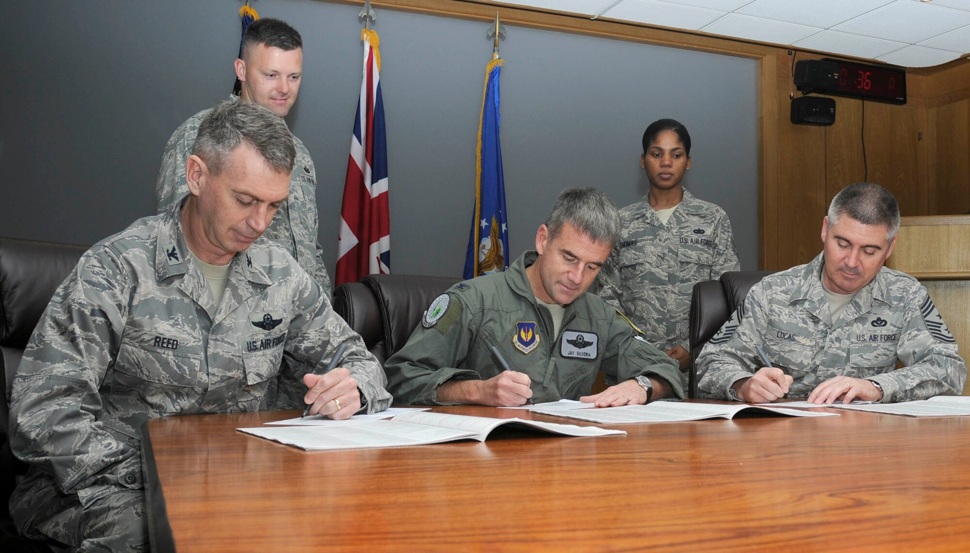 Col. Jay Silveria, 48th Fighter Wing commander (middle), Col. Lawrence Reed, 48th Fighter Wing vice commander (left) and Chief Master Sgt. James Lucas, 48th Fighter Wing command chief sign their Combined Federal Campaign pledge cards Oct. 1, 2009, on RAF Lakenheath, England. The CFC was created to provide a secure way for federal employees to choose from thousands of charities to which they can donate.   (U.S. Air Force photo/Airman 1st Class Eboni Knox).