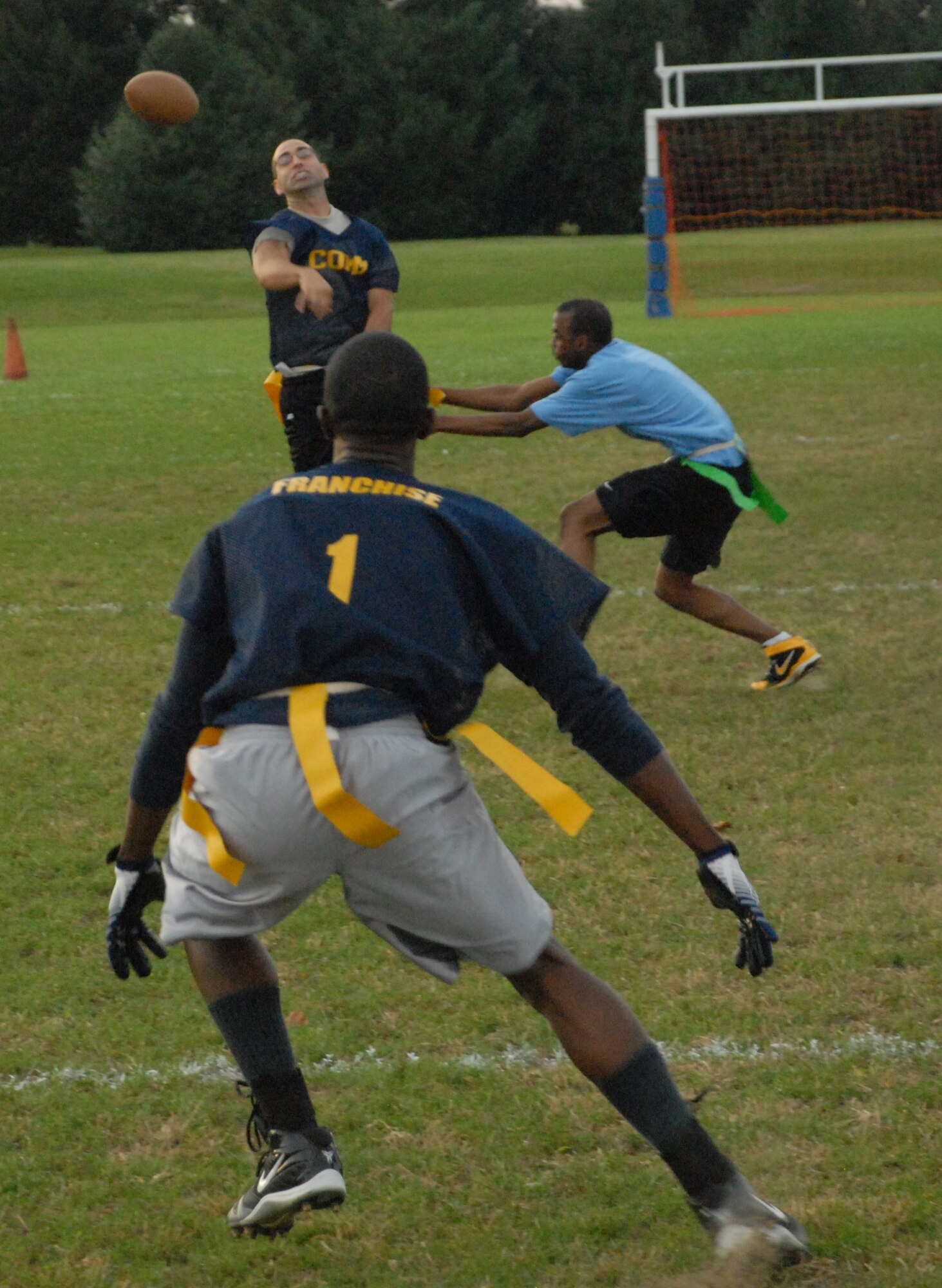 David Arceneaux, 436th Communications Squadron quarter back, throws the ball to Lamar Watson, 436th CS wide receiver, right before being ?sacked.?  The 436th CS defeated the 436th Maintenance Squadron 26 ? 0 Sept. 23.  (U.S. Air Force photo/Staff Sgt. Chad Padgett)  
