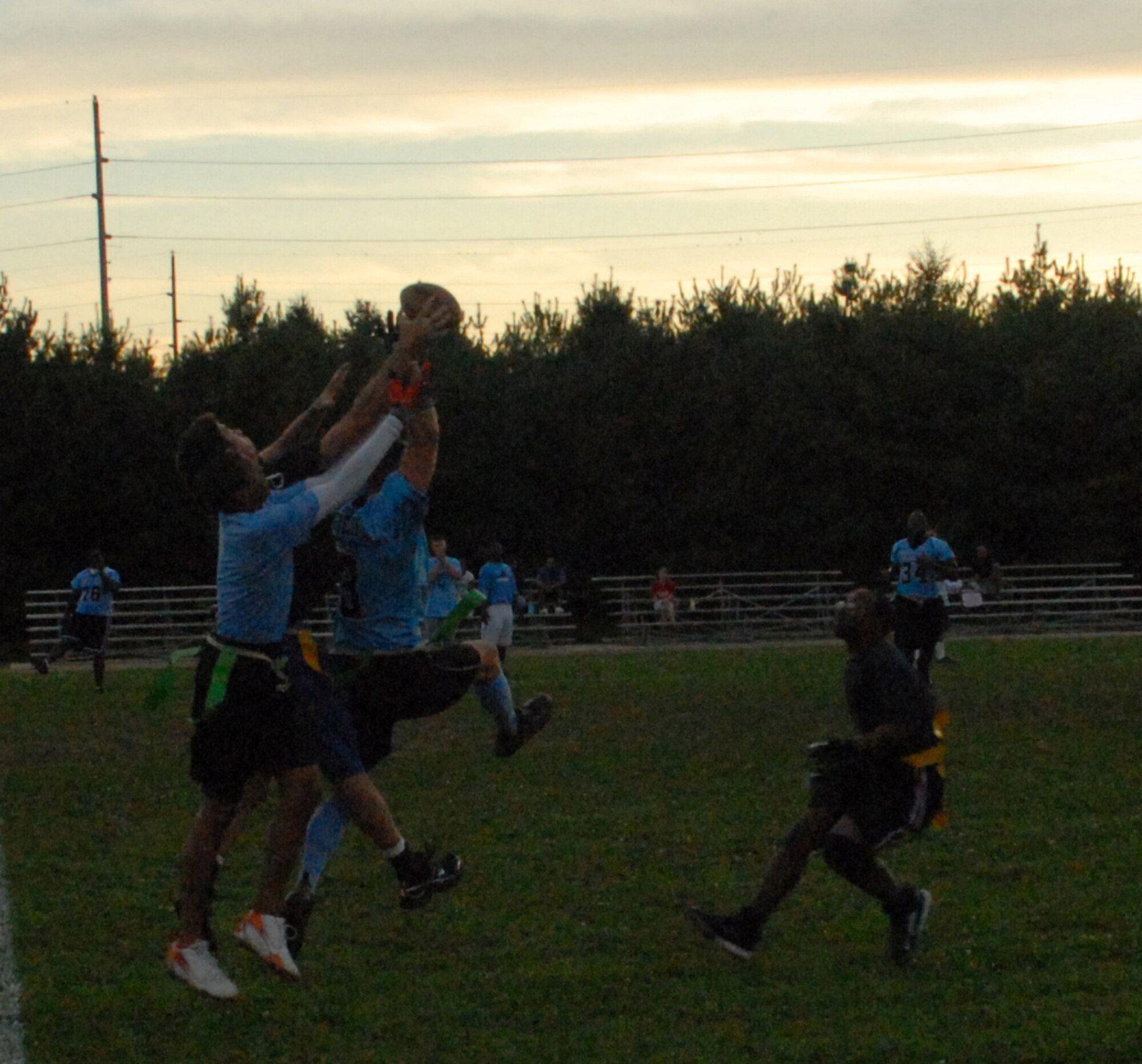 436th Communications Squadron and Maintenance Squadron members try to catch a ball during their intramural football game Sept. 23.  The 436th CS defeated the 436th Maintenance Squadron 26 ? 0.  (U.S. Air Force photo/Staff Sgt. Chad Padgett)   