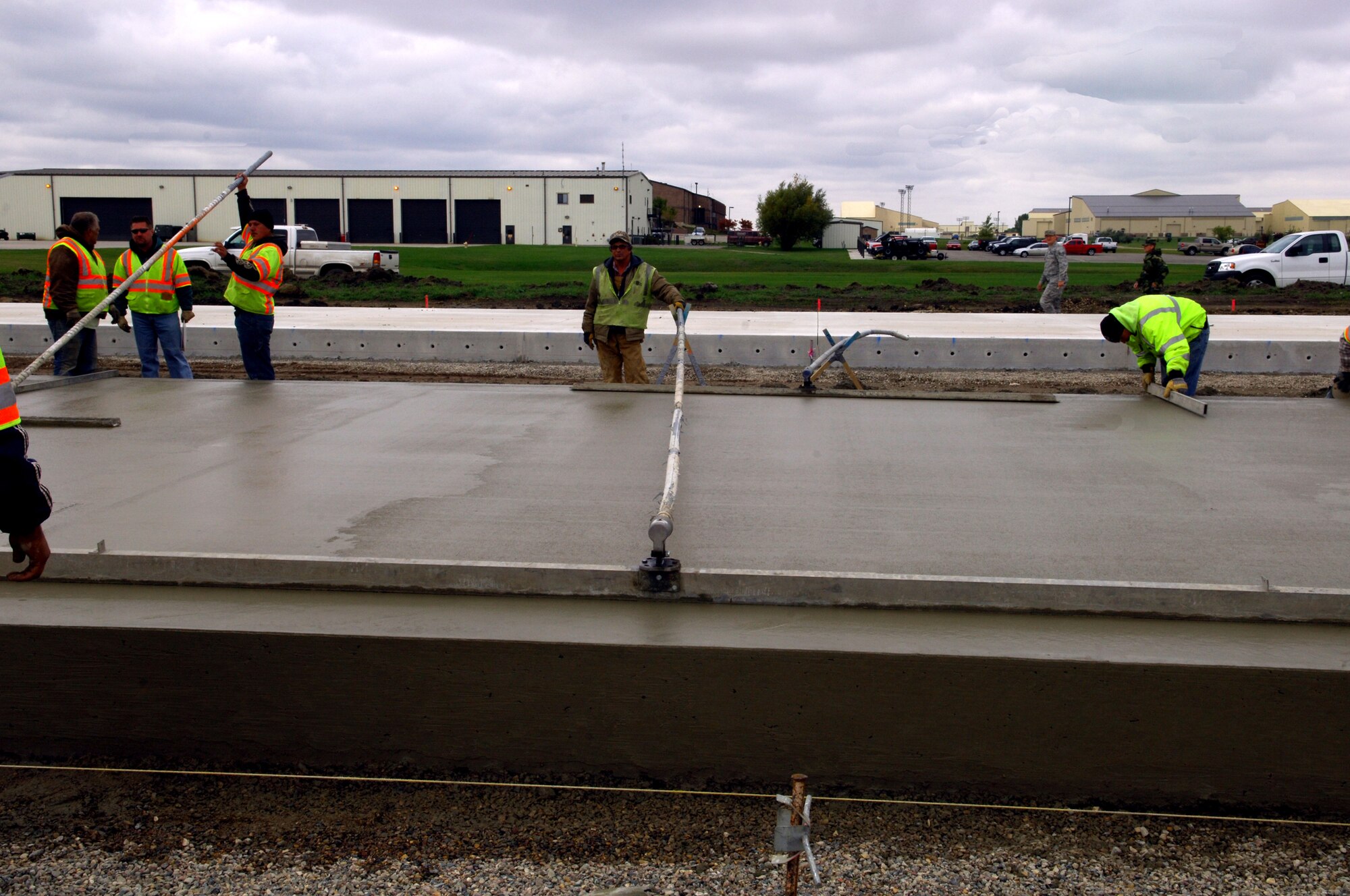 MINOT AIR FORCE BASE, N.D. -- Construction workers lay down heavy duty concrete for the transient parking apron that is 16 inches thick here, Oct. 6. Construction work like this is one of the many improvements planned for Minot AFB. (U.S. Air Force photo by Senior Airman Michael Veloz)