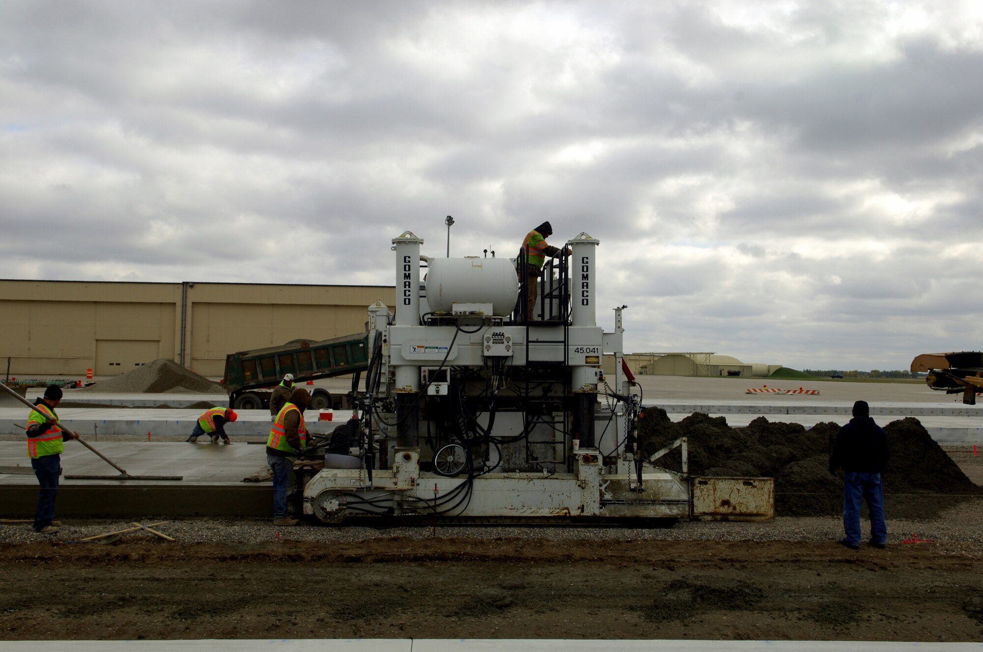 MINOT AIR FORCE BASE, N.D. -- Construction workers lay down heavy duty concrete for the transient parking apron that is 16 inches thick here, Oct. 6. Construction work like this is one of the many improvements planned for Minot AFB. (U.S. Air Force photo by Senior Airman Michael Veloz)