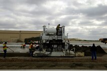 MINOT AIR FORCE BASE, N.D. -- Construction workers lay down heavy duty concrete for the transient parking apron that is 16 inches thick here, Oct. 6. Construction work like this is one of the many improvements planned for Minot AFB. (U.S. Air Force photo by Senior Airman Michael Veloz)