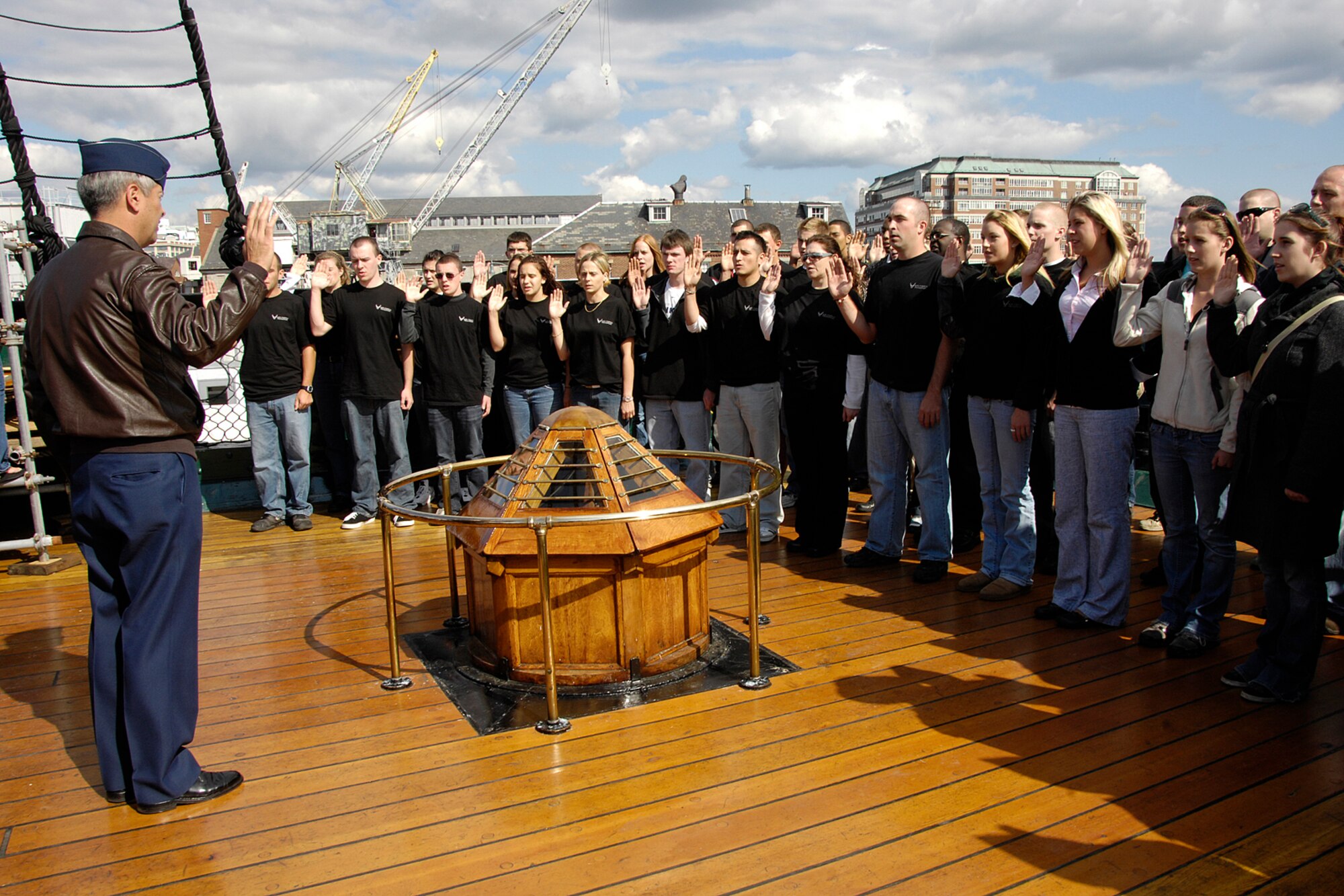 Young men and women take the oath of enlistment aboard the USS Constitution, with Col. Robert Swain Jr., 439th Airlift Wing commander, administering the oath. In all, 50 recruits joined the 439th AW while standing on board the famous ship and Boston landmark. (US Air Force photo/Linda LaBonte Britt)