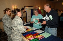 MINOT AIR FORCE BASE, N.D. -- Senior Airman Jennifer Cook and Airman Ashley Hughes, 5th Medical Operations Squadron dental assistants, talk with John and Patricia Reinert, Bismarck, N.D. natives, during retiree appreciation day here, Oct. 2. The 5th Bomb Wing and 91st Missile Wing sponsored the 2009 Military Retiree Appreciation Day to say thank you to the area’s retirees and their families for their service and sacrifice made throughout their military career. The event enabled numerous base agencies to present updates and issues of importance to retirees through an informational fair and afternoon of briefings. (U.S. Air Force photo by Senior Airman Matthew Smith)