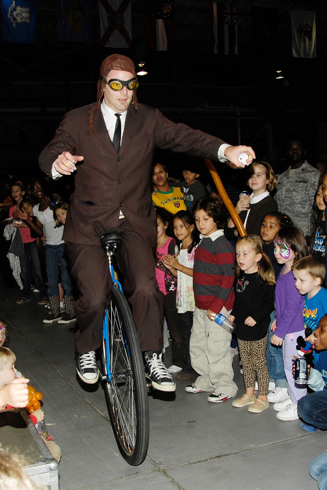 HANSCOM AIR FORCE BASE, Mass. – John Higby, of the Yo-Yo’s, performs on his unicycle during Hanscom’s Oktoberfest celebration Oct. 2, at the Aero Club hangar. The Yo-Yo’s, a husband and wife team captivated the audience’s attention with their juggling and Yo-Yo skills. Oktoberfest featured activities, games, food and live entertainment for the entire Hanscom community. The event is one of many that Hanscom has lined up to help celebrate the Year of the Air Force Family that runs until July 2010. For more information on upcoming events and activities go online to www.hanscomservices.com.  (U.S. Air Force photo by Linda LaBonte Britt)