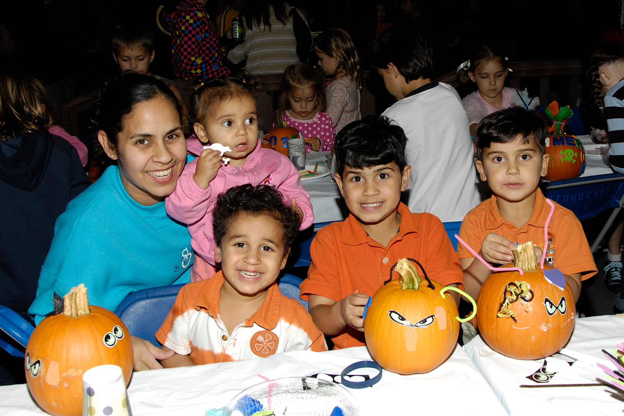 HANSCOM AIR FORCE BASE, Mass. – Leonor Ayala enjoys some family pumpkin decorating time at Oktoberfest with her children (from left to right) Alondra, Markos, Gabriel and Leomar. Oktoberfest took place Oct. 2, at the Aero Club hangar and featured activities, games and live entertainment for the entire family to enjoy. The event is one of many that Hanscom has lined up to help celebrate the Year of the Air Force Family that runs until July 2010. For more information on upcoming events and activities go online to www.hanscomservices.com. (U.S. Air Force photo by Linda LaBonte Britt)