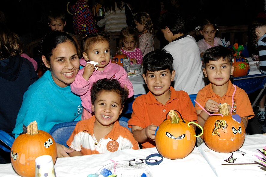 HANSCOM AIR FORCE BASE, Mass. – Leonor Ayala enjoys some family pumpkin decorating time at Oktoberfest with her children (from left to right) Alondra, Markos, Gabriel and Leomar. Oktoberfest took place Oct. 2, at the Aero Club hangar and featured activities, games and live entertainment for the entire family to enjoy. The event is one of many that Hanscom has lined up to help celebrate the Year of the Air Force Family that runs until July 2010. For more information on upcoming events and activities go online to www.hanscomservices.com. (Air Force photo by Linda LaBonte Britt) 