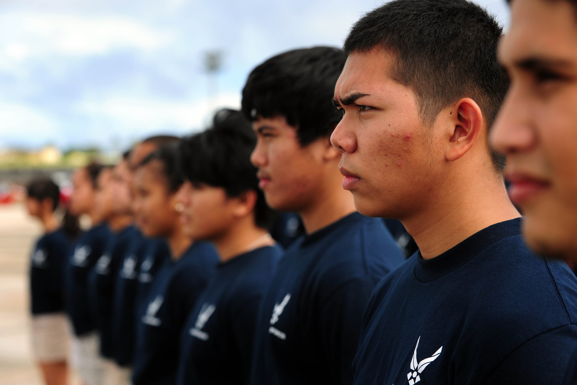 ANDERSEN AIR FORCE BASE, Guam - Local high school students from Guam wait patiently before the enlistment ceremony with the Thunderbirds here during Team Andersen Air Show '09 "Air Power Over the Marianas" Oct. 7. The U.S. Air Force Thunderbirds is the premier aerial demonstration team representing Airmen worldwide. Andersen AFB rescheduled its air show for after cancelling it due to Typhoon Melor.  The air show was held primarily to thank the residents of Guam for their continued support to Andersen AFB and the rest of the U.S. Air Force. (U.S. Air Force photo by Airman 1st Class Courtney Witt)
