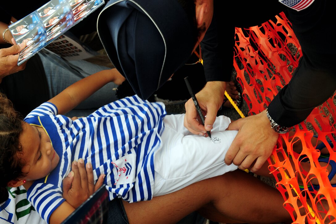 ANDERSEN AIR FORCE BASE, Guam - A little girl receives an autograph from a Thunderbirds pilot after an aerial demonstration during Team Andersen Air Show '09 "Air Power Over the Marianas" here Oct. 7. The U.S. Air Force Thunderbirds is the premier aerial demonstration team representing Airmen worldwide. Andersen AFB rescheduled its air show for after cancelling it due to Typhoon Melor.  The air show was held primarily to thank the residents of Guam for their continued support to Andersen AFB and the rest of the U.S. Air Force. (U.S. Air Force photo by Airman 1st Class Courtney Witt)
