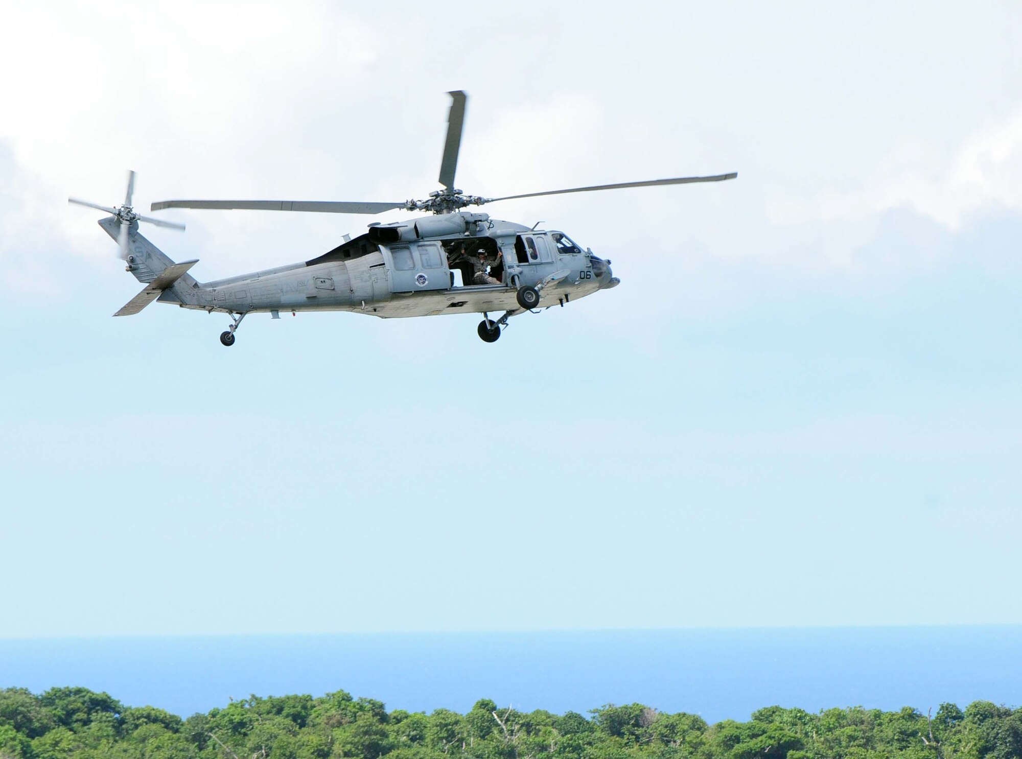 ANDERSEN AIR FORCE BASE, Guam - A Navy MH-60S Knighthawk from the Helicopter Sea Combat Squadron-Two Five hovers over Andersen AFB's air field, Oct. 7. The Kighthawk was one of four aerial displays that participated in the Team Anderson Air Show '09 "Air Power over the Marianas." The Knighthawk crew airlifted Airmen from the 554th RED HORSE Squadron to their insertion point allowing the Airmen to conduct a fast rope demonstration.   (U.S. Air Force photo by Airman 1st Class Julian North/Released)
