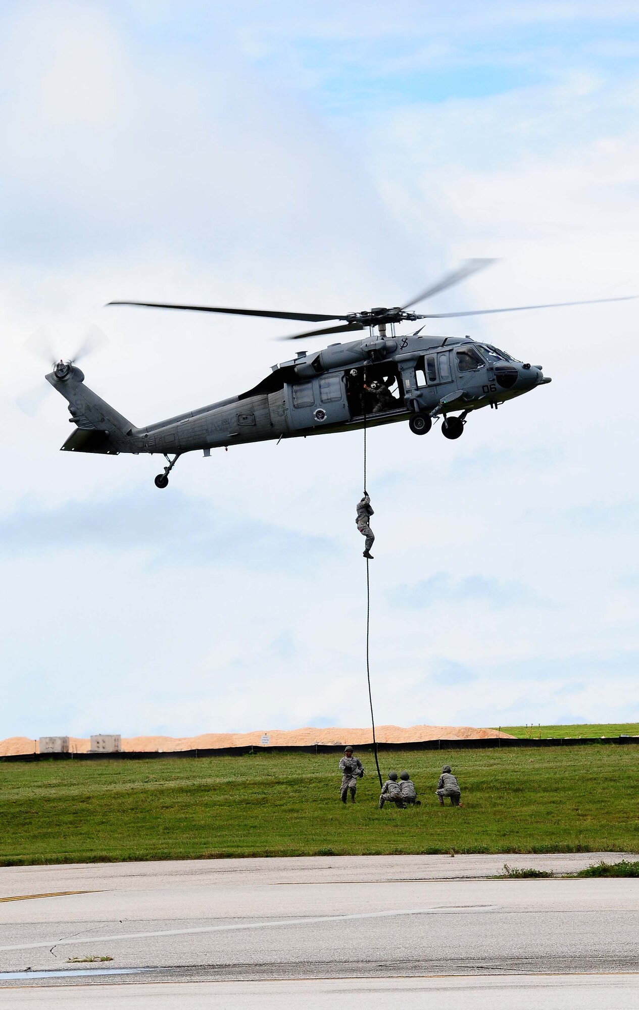 ANDERSEN AIR FORCE BASE, Guam - Airmen from the 554th RED HORSE Squadron fast rope out of a MH-60S Knighthawk helicopter from Navy's Helicopter Sea Combat Squadron-Two Five during the Team Andersen Air Show ‘09 "Air Power over the Marianas" Oct. 7, 2009.  The technique is used to access areas where helicopters or other aircraft can’t land. (U.S. Air Force photo by Senior Airman Nichelle Anderson)