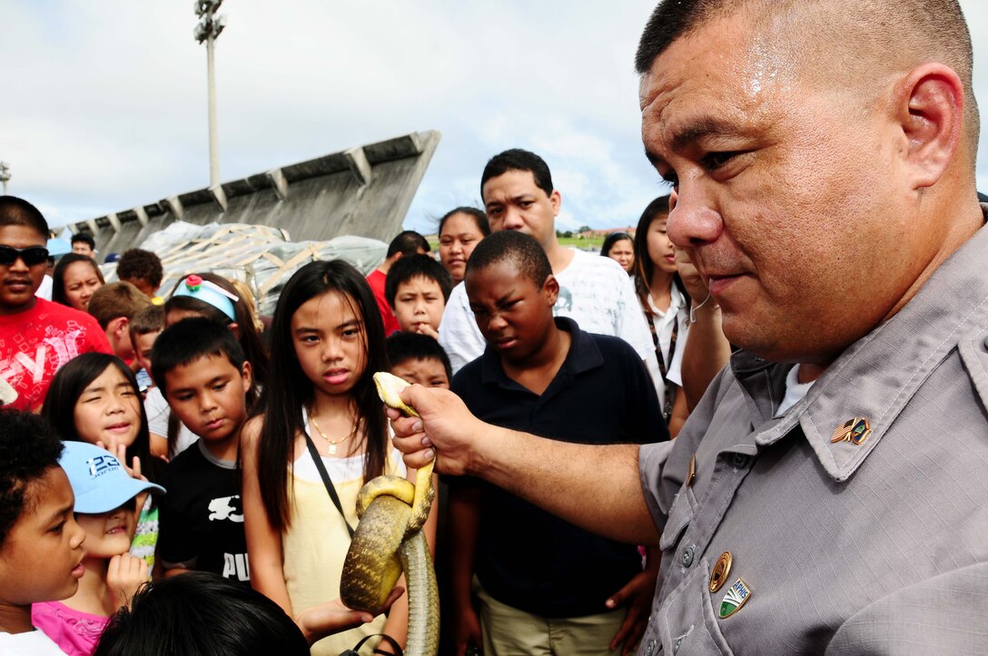 ANDERSEN AIR FORCE BASE, Guam - Anthony Pangelinan, United States Department of Agriculture training instructor, displays a brown tree snake during the Team Andersen Air Show '09 "Air Power over the Marianas" Oct. 7, 2009.  The last air show held at Andersen was in 2004. (U.S. Air Force photo by Senior Airman Nichelle Anderson)