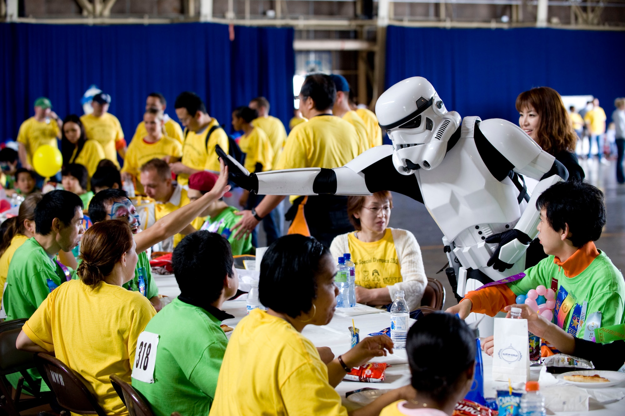 MISAWA AIR BASE, Japan -- A Stormtrooper high-fives a Special Olympics athlete in Hanger 949 Oct. 3. The 23rd annual Misawa Air Base Special Olympics also gave Americans a chance to share their culture with the Japanese athletes. (U.S. Air Force photo/Staff Sgt. Samuel Morse)