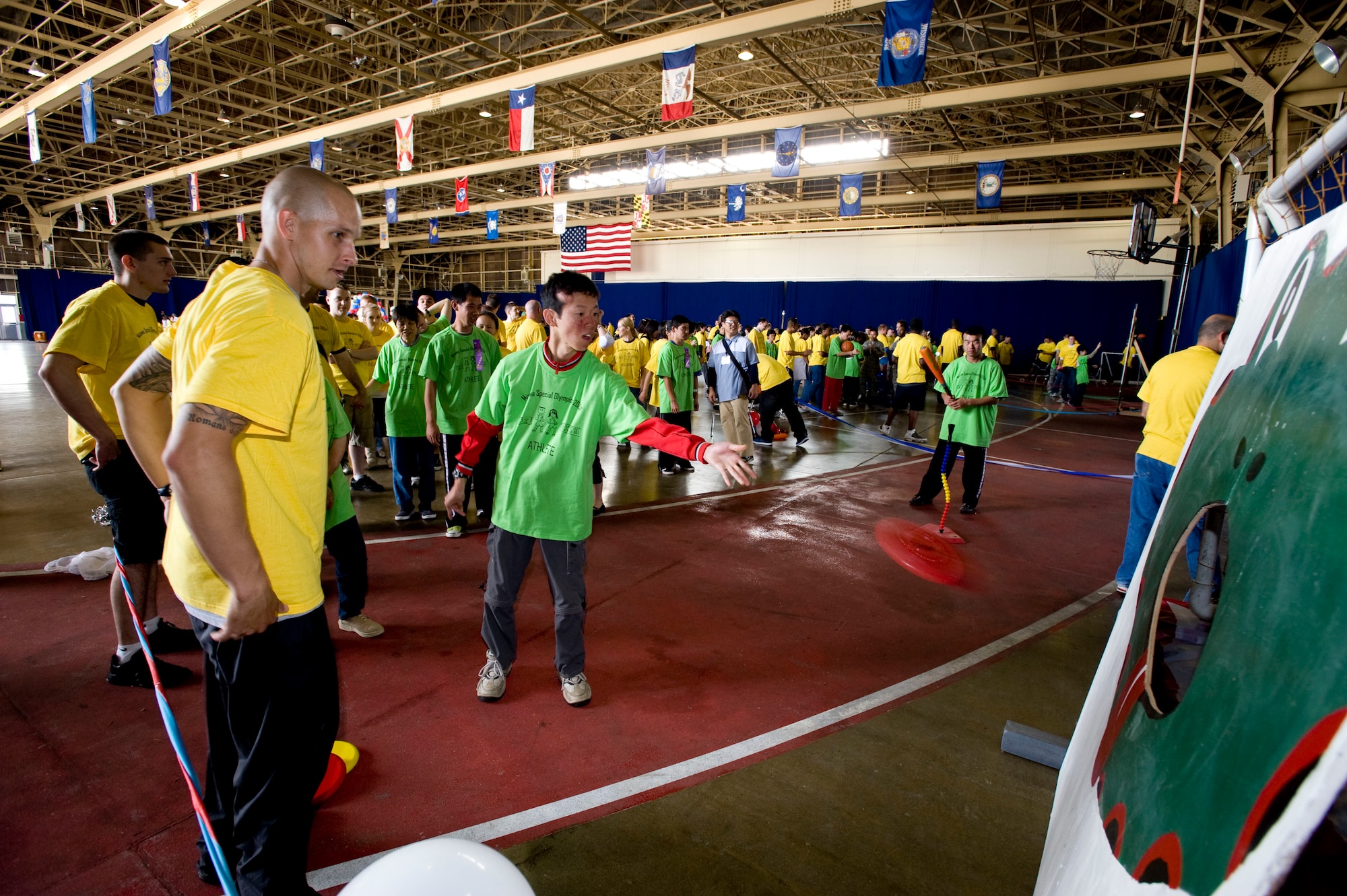 MISAWA AIR BASE, Japan -- A Special Olympics athlete throws a frisbee during the frisbee toss competition in Hanger 949 Oct. 3. All the athletes received a ribbon for participating. (U.S. Air Force photo/Staff Sgt. Samuel Morse)