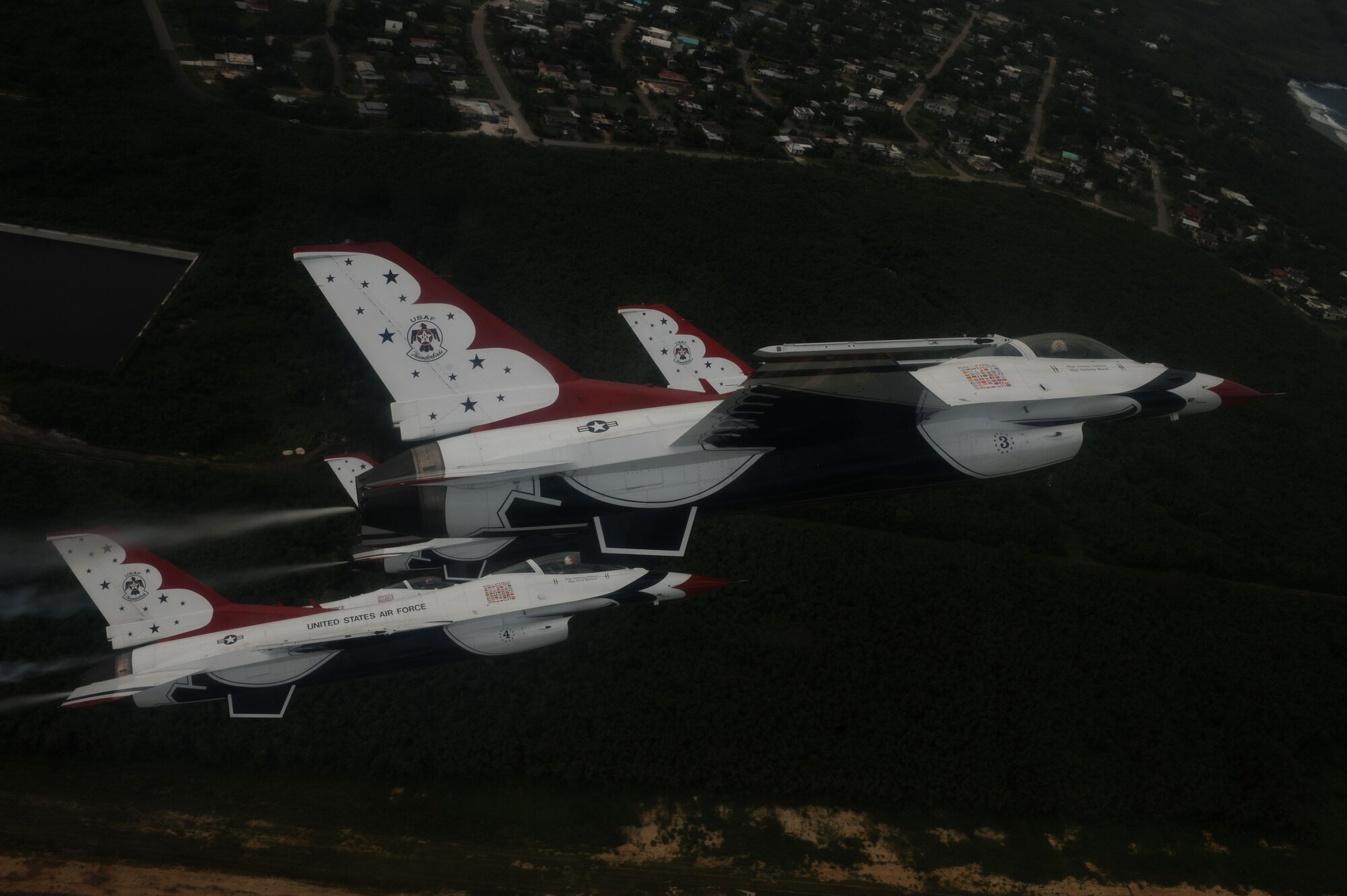 The U.S. Air Force Thunderbirds fly in formation over Saipan Oct. 6.  The Thunderbirds flew over Saipan before conducting their practice demonstration over Andersen Air Force Base, Guam.  The Thunderbirds are visiting Andersen AFB for the Team Andersen Air Show '09 on Oct. 7.  (Air Force photo by Staff Sgt. Kristi Machado)