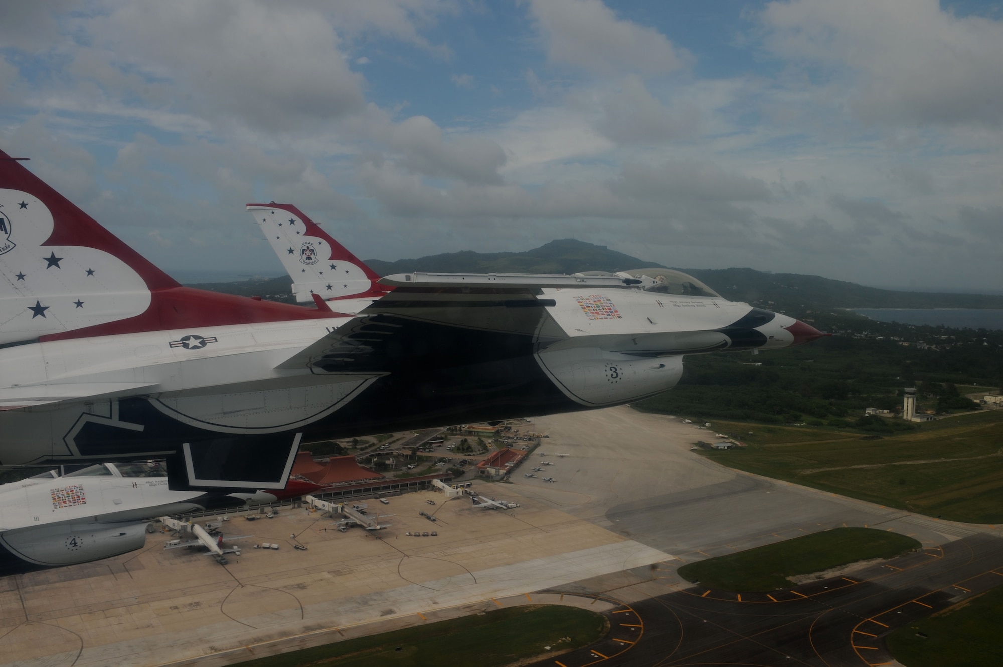 The U.S. Air Force Thunderbirds fly in formation over Saipan Oct. 6.  The Thunderbirds flew over Saipan before conducting their practice demonstration over Andersen Air Force Base, Guam.  The Thunderbirds are visiting Andersen AFB for the Team Andersen Air Show '09 on Oct. 7.  (Air Force photo by Staff Sgt. Kristi Machado)