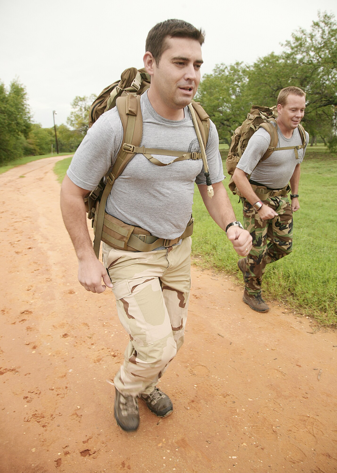 1st Lt. Sam Schindler (left) and Master Sgt. Kenneth Huhman prepare at Lackland Training Annex, Texas, for the 150 mile ruck march they will be doing to honor 12 fallen special tactics Airmen killed in Iraq and Afghanistan. Lieutenant Schindler and Sergeant Huhman are both with the 342nd Training Squadron at Lackland AFB. (U.S. Air Force photo/Robbin Cresswell) 
