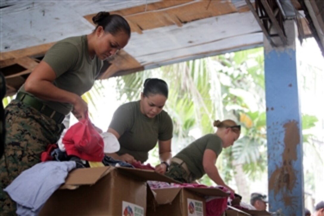 U.S. Marines assigned to the III Marine Expeditionary Force sort donated clothes before distributing them to flood victims at an evacuation center in the Philippines on Oct. 2, 2009.  Flooding caused by several typhoons has destroyed homes in the area and has displaced thousands of residents.  